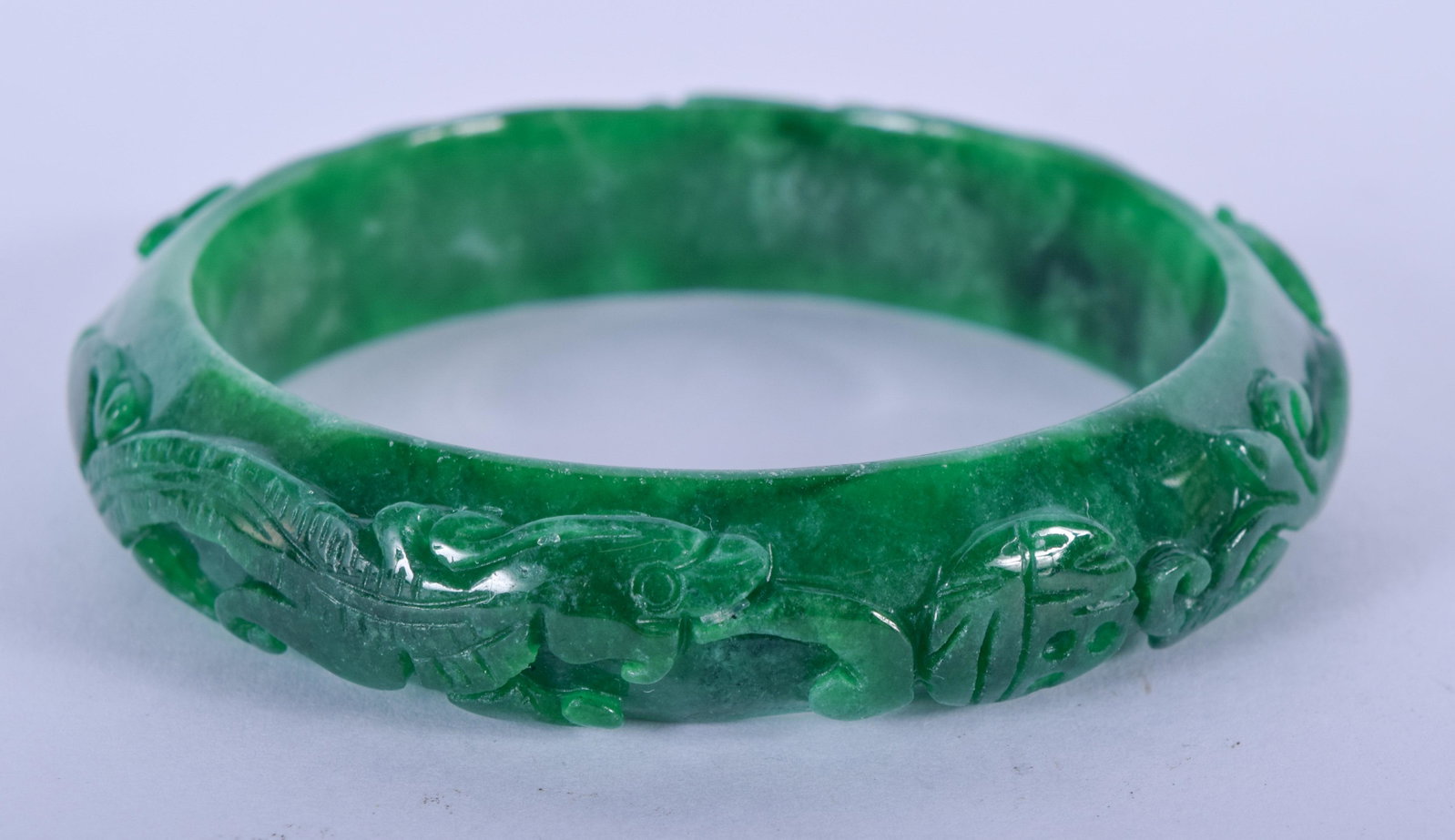 A CHINESE JADEITE BANGLE. 7.25 cm wide.: A CHINESE JADEITE BANGLE. 7.25 cm wide.