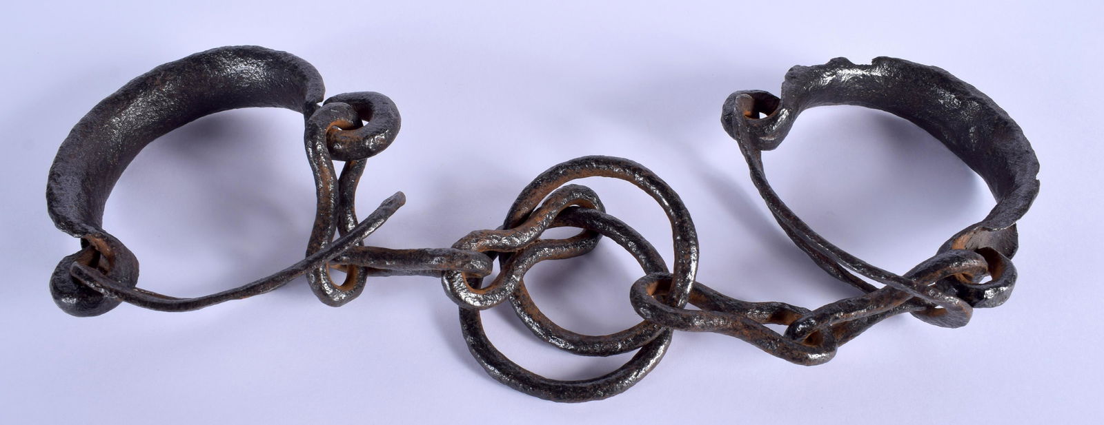 A PAIR OF VICTORIAN CAST IRON SLAVERY LEG IRONS. 45 cm: A PAIR OF VICTORIAN CAST IRON SLAVERY LEG IRONS. 45 cm long.
