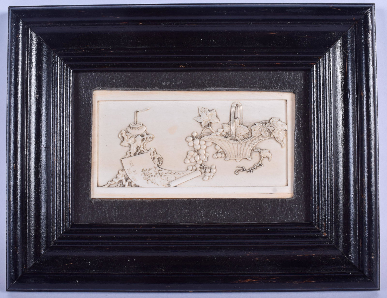 A 19TH CENTURY JAPANESE MEIJI PERIOD CARVED BONE: A 19TH CENTURY JAPANESE MEIJI PERIOD CARVED BONE RECTANGULAR PANEL depicting urns of foliage and scrolls. BONE 12 cm x 6.5 cm.