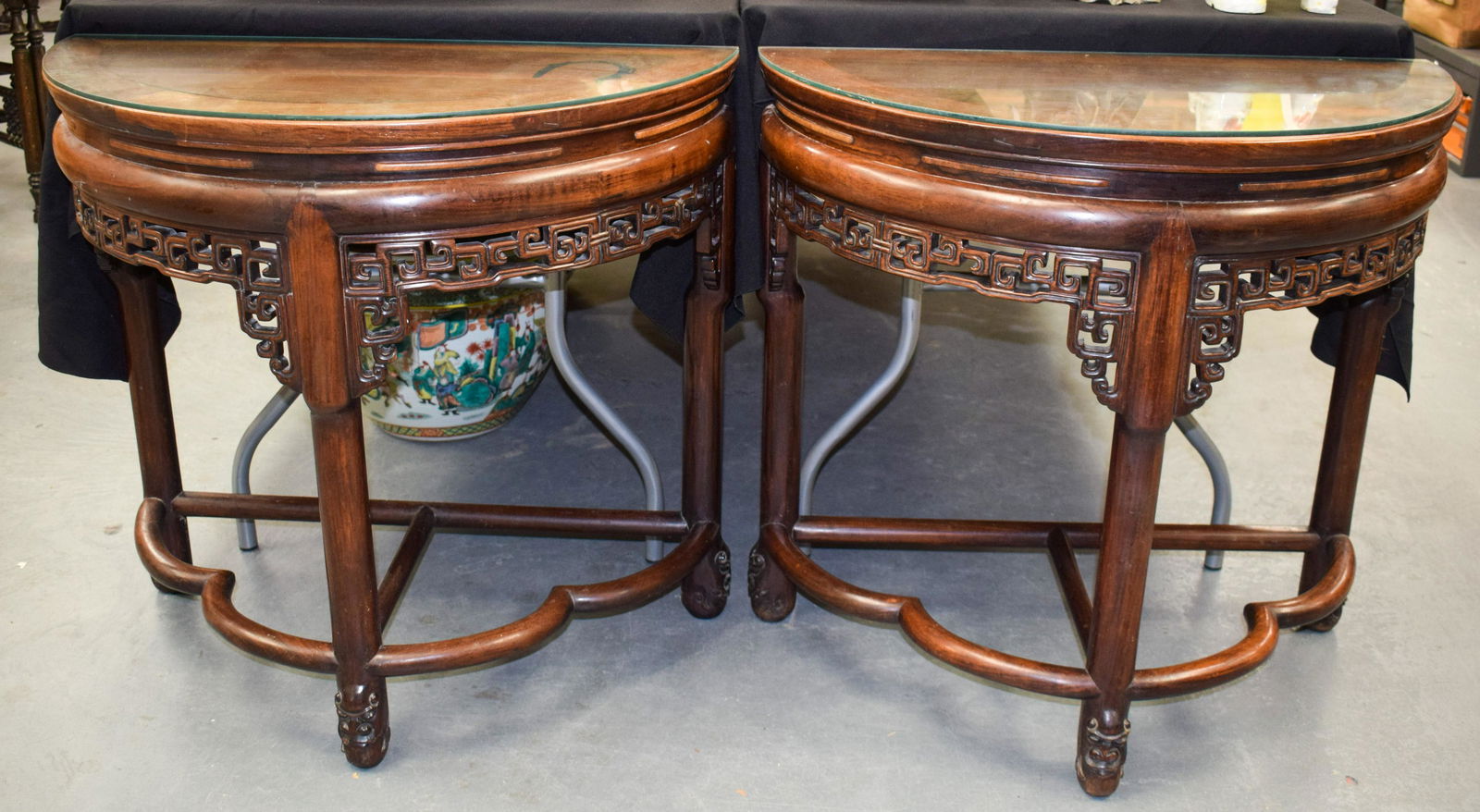 A RARE PAIR OF 19TH CENTURY CHINESE CARVED HONGMU DEMI: A RARE PAIR OF 19TH CENTURY CHINESE CARVED HONGMU DEMI LUNE CONSOLE TABLES Qing, of highly unusual form, with buddhistic mask head mounts. 72 cm x 76 cm.