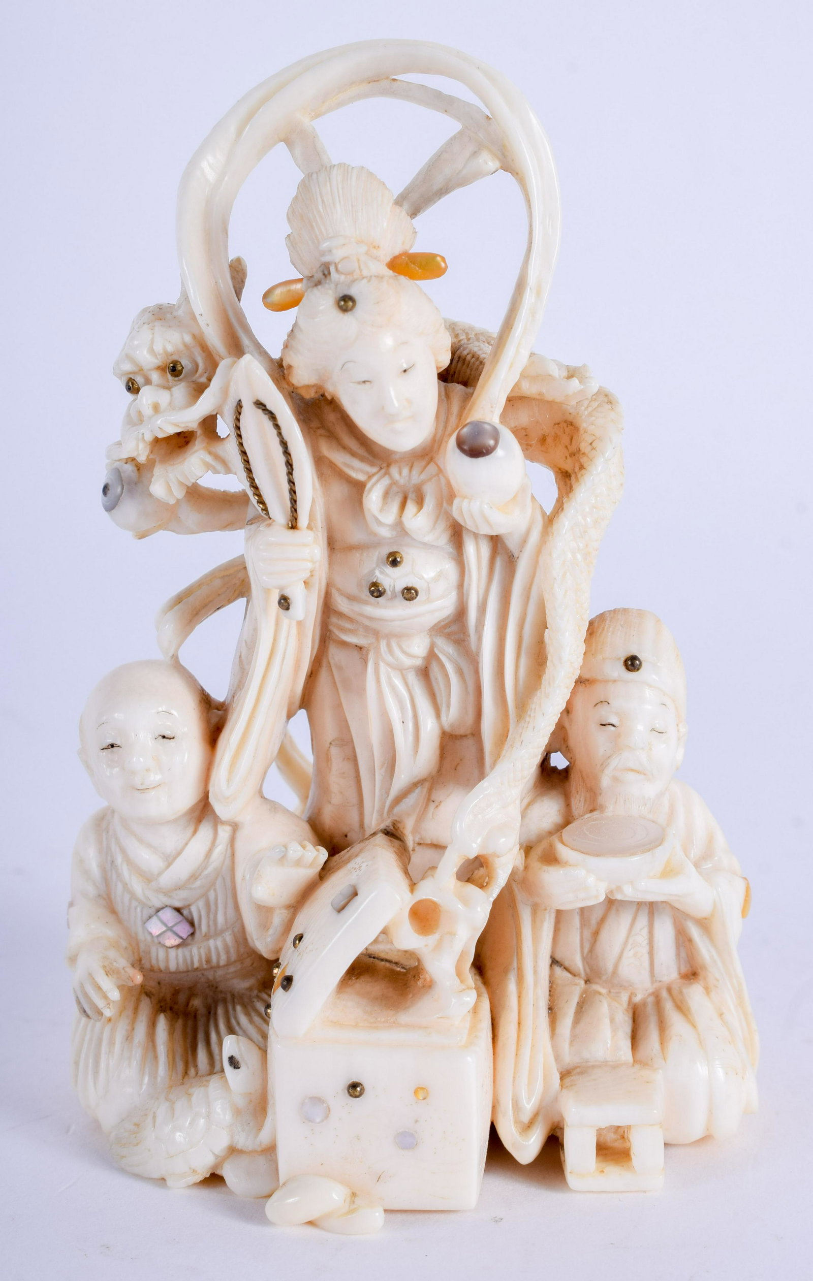 A 19TH CENTURY JAPANESE MEIJI PERIOD CARVED BONE: A 19TH CENTURY JAPANESE MEIJI PERIOD CARVED BONE OKIMONO modelled as a daoist immortal with two others. 8.5 cm x 5 cm.