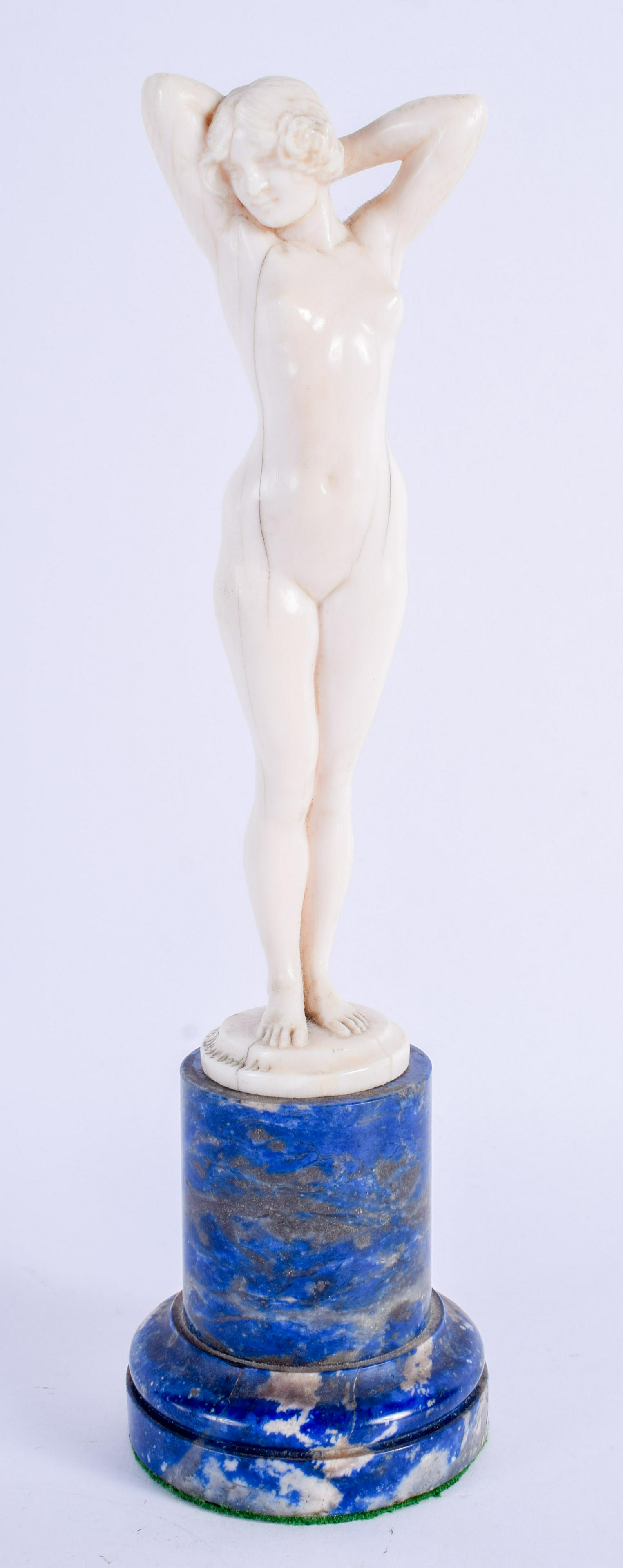 A FINE ART DECO CARVED BONE AND LAPIS LAZULI FIGURE OF: A FINE ART DECO CARVED BONE AND LAPIS LAZULI FIGURE OF A NUDE FEMALE by Joe Descomps (1872-1948). 22 cm high.