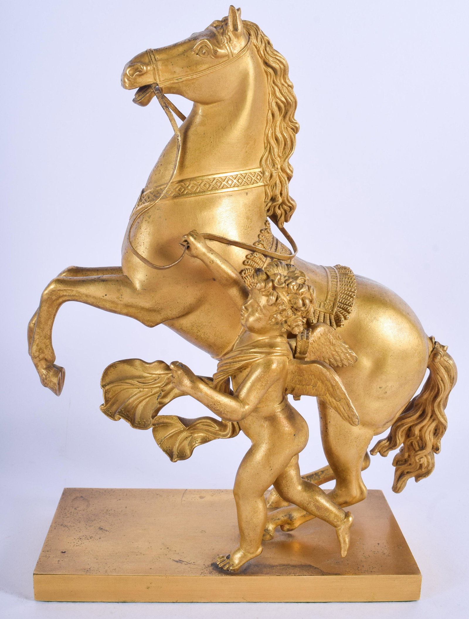 AN EARLY 19TH CENTURY FRENCH EMPIRE ORMOLU FIGURE OF A: AN EARLY 19TH CENTURY FRENCH EMPIRE ORMOLU FIGURE OF A REARING HORSE modelled beside a putti. 28 cm x 17 cm.