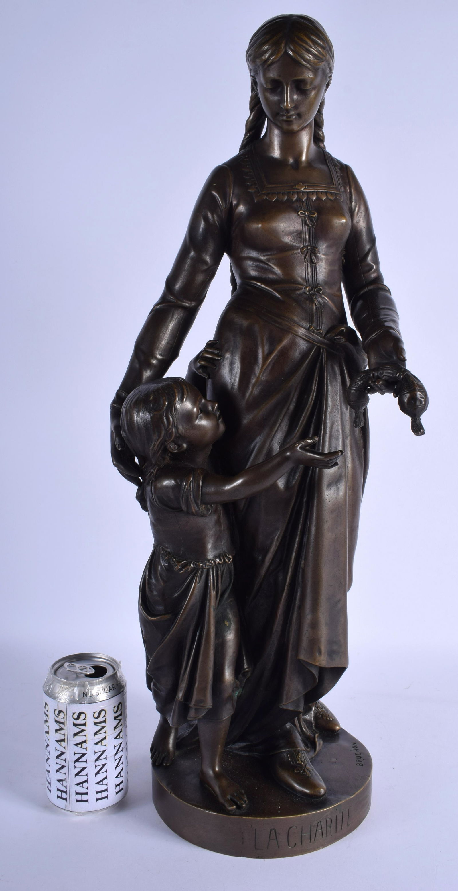 A LARGE ANTIQUE FRENCH BELLE EPOQUE FIGURE OF A FEMALE: A LARGE ANTIQUE FRENCH BELLE EPOQUE FIGURE OF A FEMALE by Emile Bruchon (C1910), modelled standing beside a child. 57 cm high.