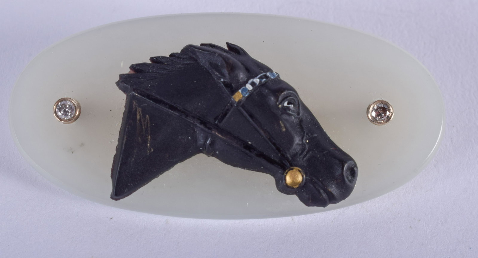 A 1930S GOLD DIAMOND AND JADE EQUESTRIAN HORSE BROOCH.: A 1930S GOLD DIAMOND AND JADE EQUESTRIAN HORSE BROOCH. 5.5 cm wide.