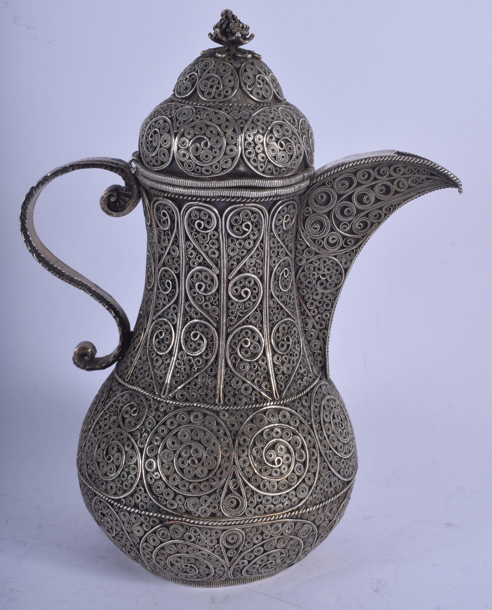 A 19TH CENTURY MIDDLE EASTERN TURKISH SILVER FILIGREE: A 19TH CENTURY MIDDLE EASTERN TURKISH SILVER FILIGREE EWER decorated with swirls and foliage. 465 grams. 17.5 cm high.