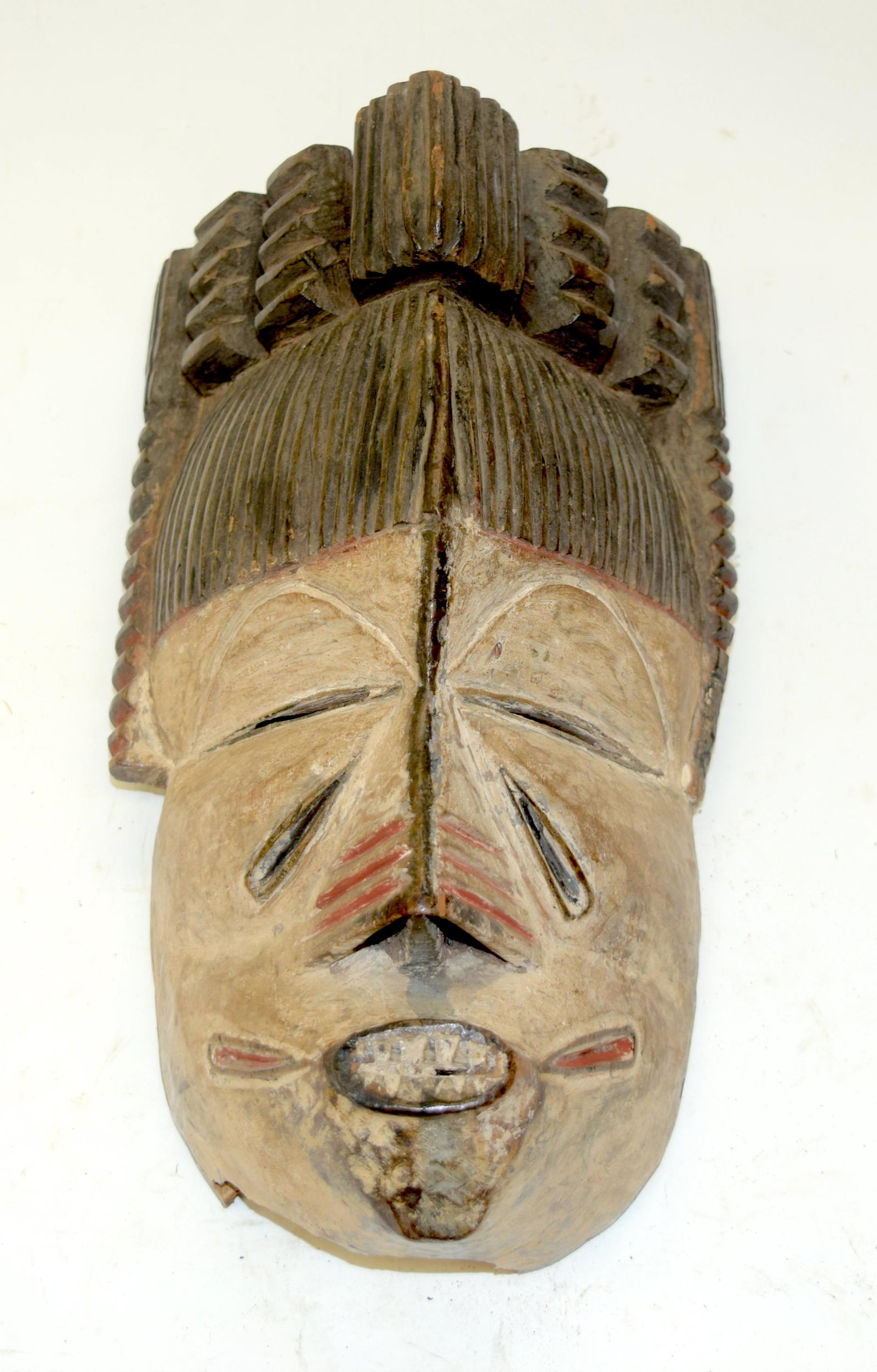 A TRIBAL IGBO MASK. Nigeria. 16cm x 10cm x 27cm: A TRIBAL IGBO MASK. Nigeria. 16cm x 10cm x 27cm
