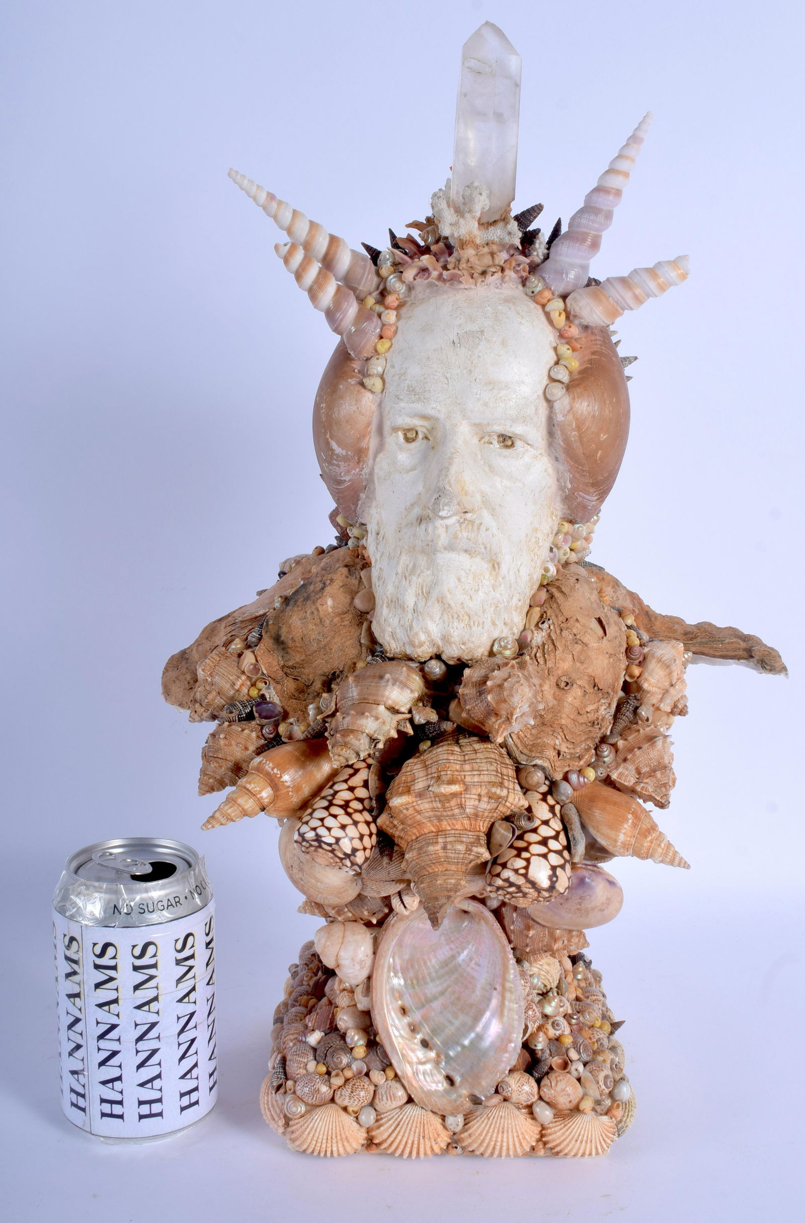 A RARE VINTAGE SHELL FIGURE OF A SEA GOD modelled: A RARE VINTAGE SHELL FIGURE OF A SEA GOD modelled as a bearded male within a naturalistic setting. 45 cm x 23 cm.