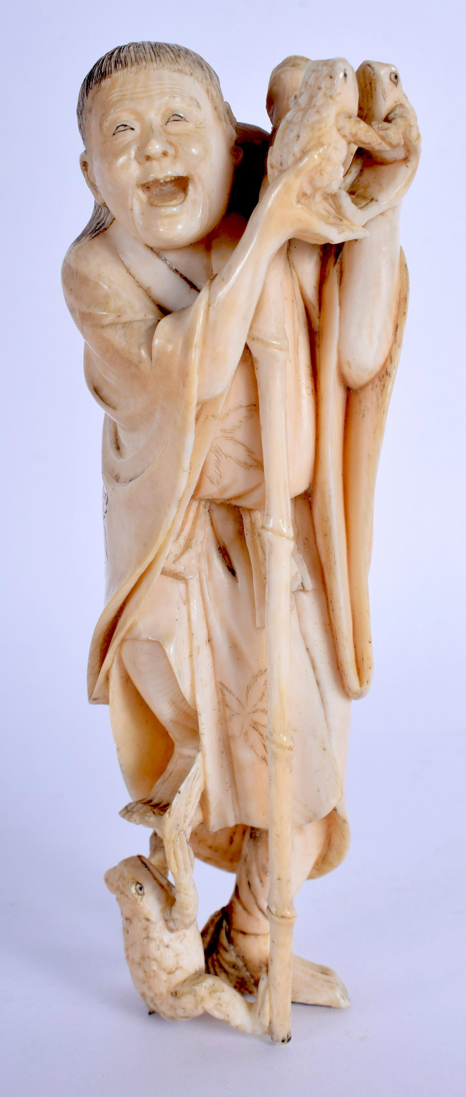 A 19TH CENTURY JAPANESE MEIJI PERIOD CARVED bone: A 19TH CENTURY JAPANESE MEIJI PERIOD CARVED bone FIGURE OF A MALE modelled holding toads. 12.5 cm high.