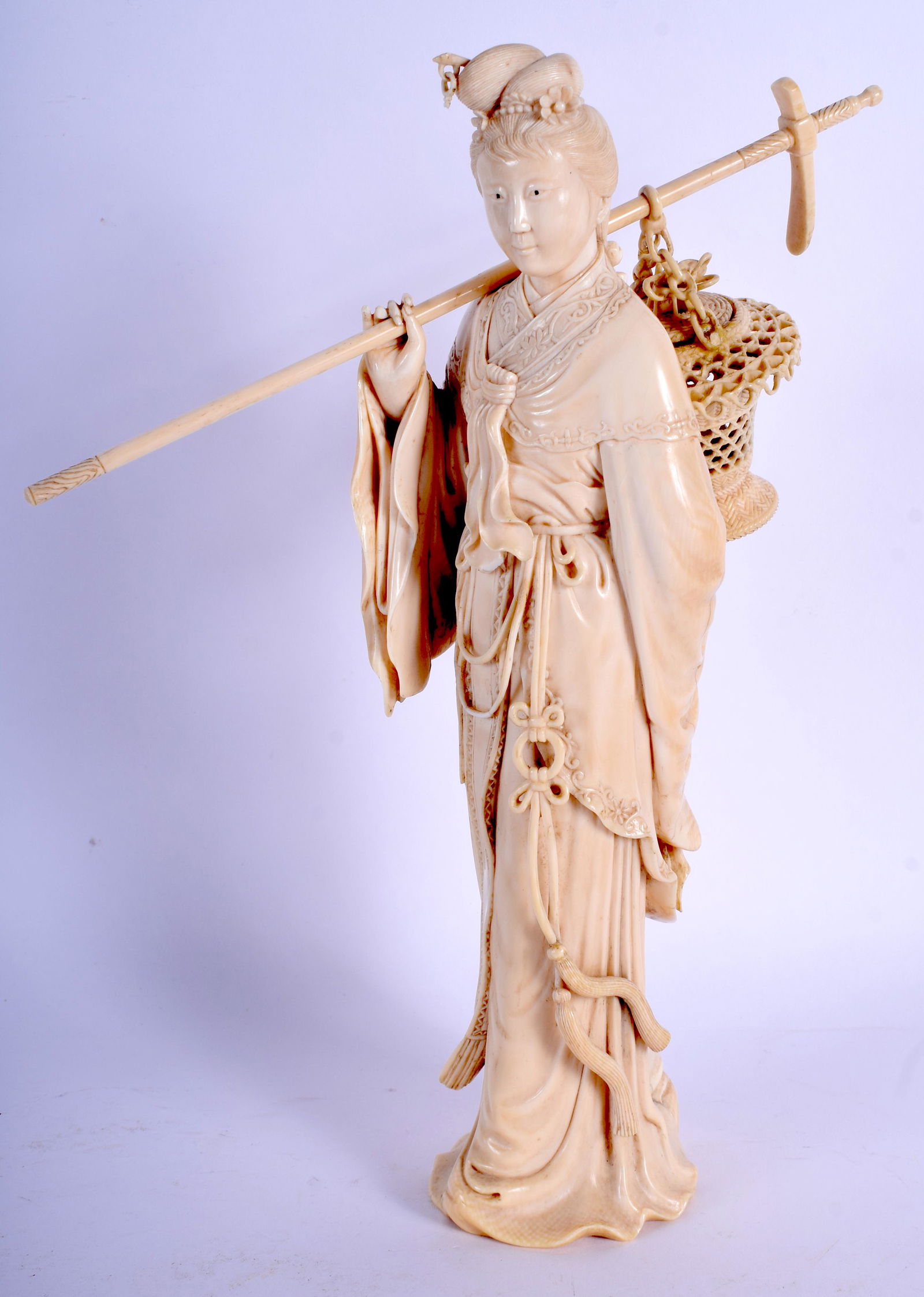 A 19TH CENTURY CHINESE CARVED bone FIGURE OF A FE: A 19TH CENTURY CHINESE CARVED bone FIGURE OF A FEMALE modelled holding a basket in flowing robes. 24.5 cm high.