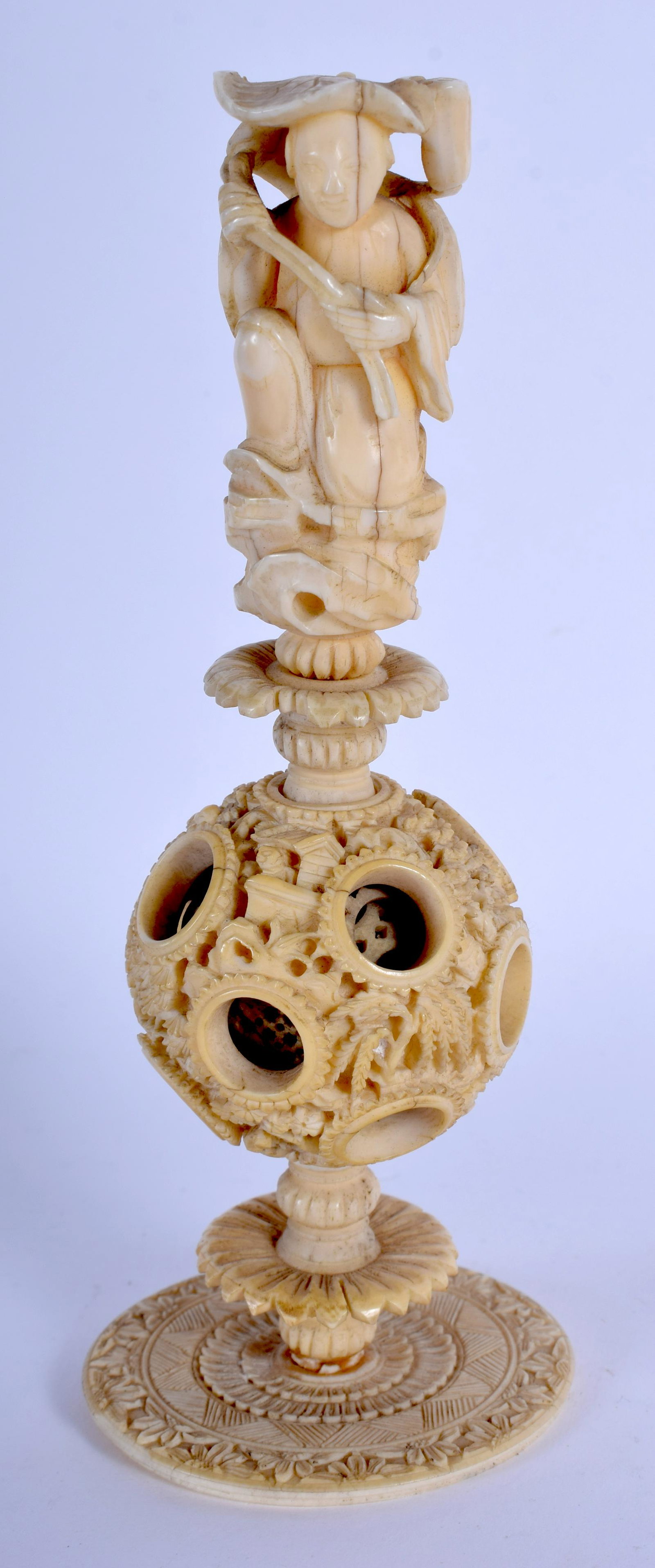 A 19TH CENTURY CHINESE CARVED bone PUZZLE BALL fo: A 19TH CENTURY CHINESE CARVED bone PUZZLE BALL formed as a male holding a lotus. 16 cm high.