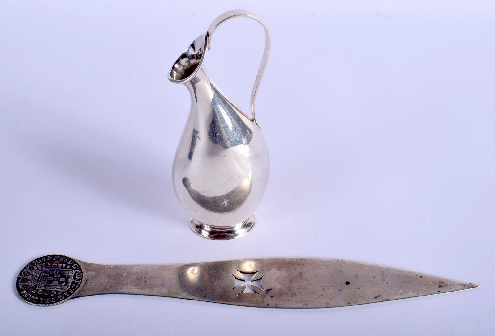 A STYLISH DANISH SILVER JUG and a silver coin let: A STYLISH DANISH SILVER JUG and a silver coin letter opener. 121 grams. Largest 23 cm long. (2)