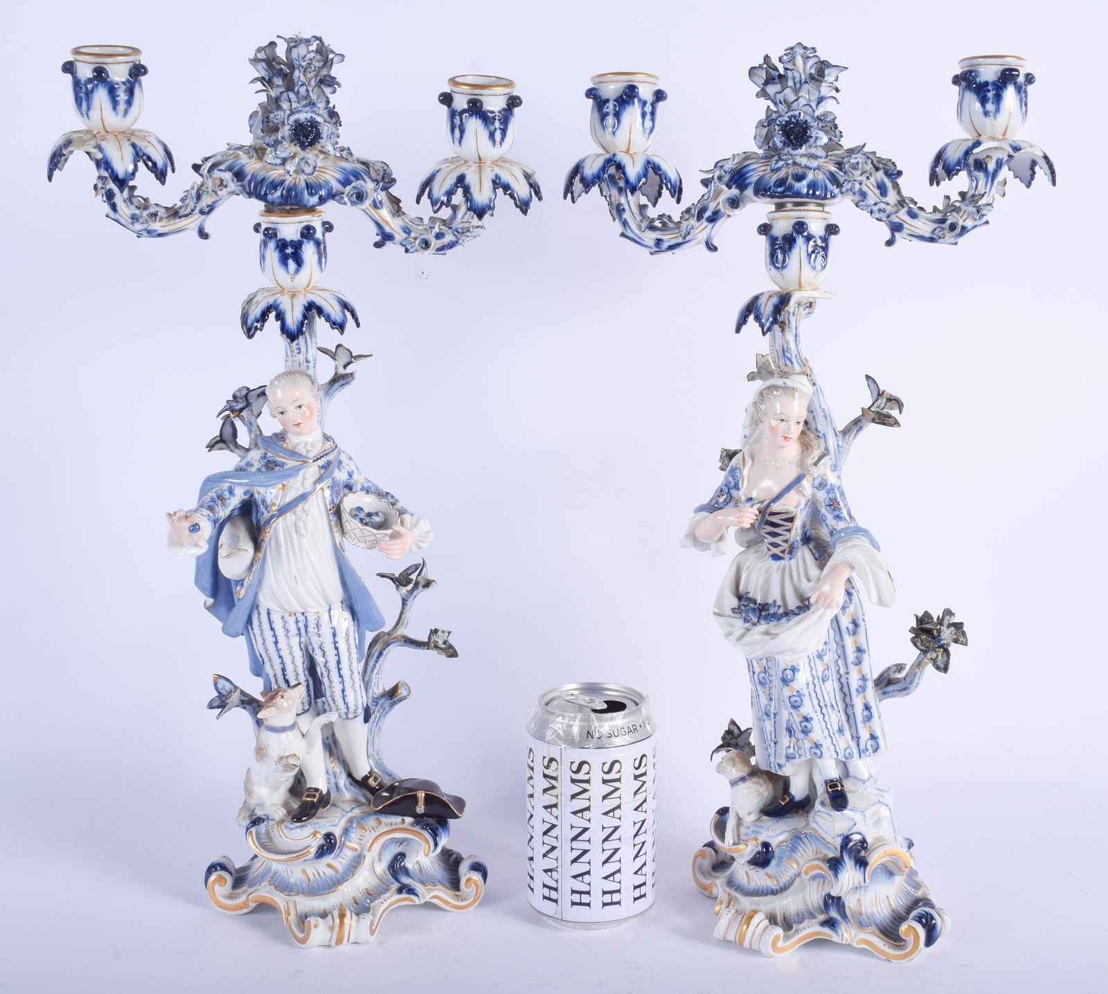 A LARGE PAIR OF 19TH CENTURY MEISSEN PORCELAIN CA: A LARGE PAIR OF 19TH CENTURY MEISSEN PORCELAIN CANDLESTICKS modelled as a male and female upon a rococo base. 44 cm x 16 cm.
