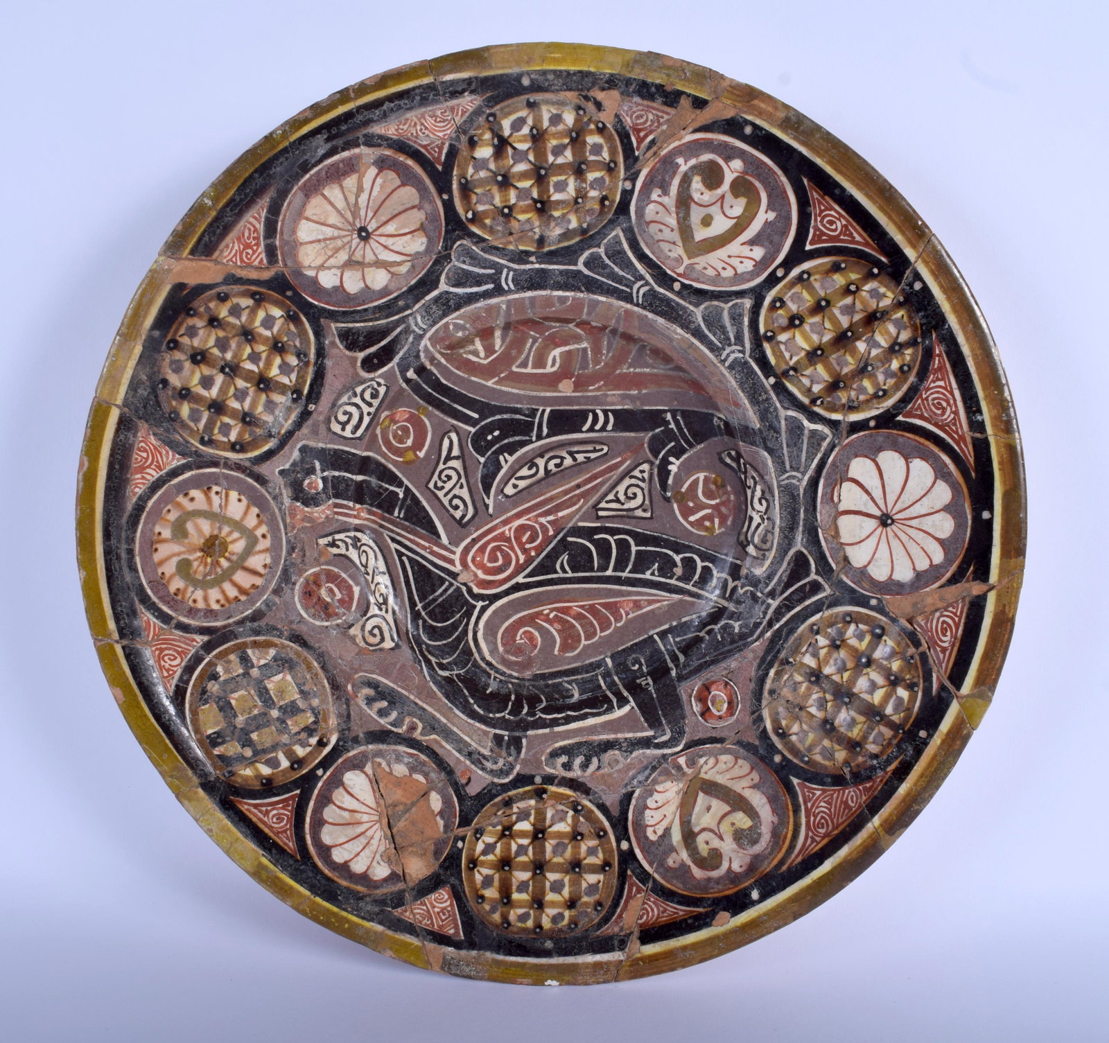 A 10TH CENTURY SAMARKAND CIRCULAR POTTERY BOWL Central: A 10TH CENTURY SAMARKAND CIRCULAR POTTERY BOWL Central Asia, painted with a bird like motif and floral roundels. 38 cm diameter.