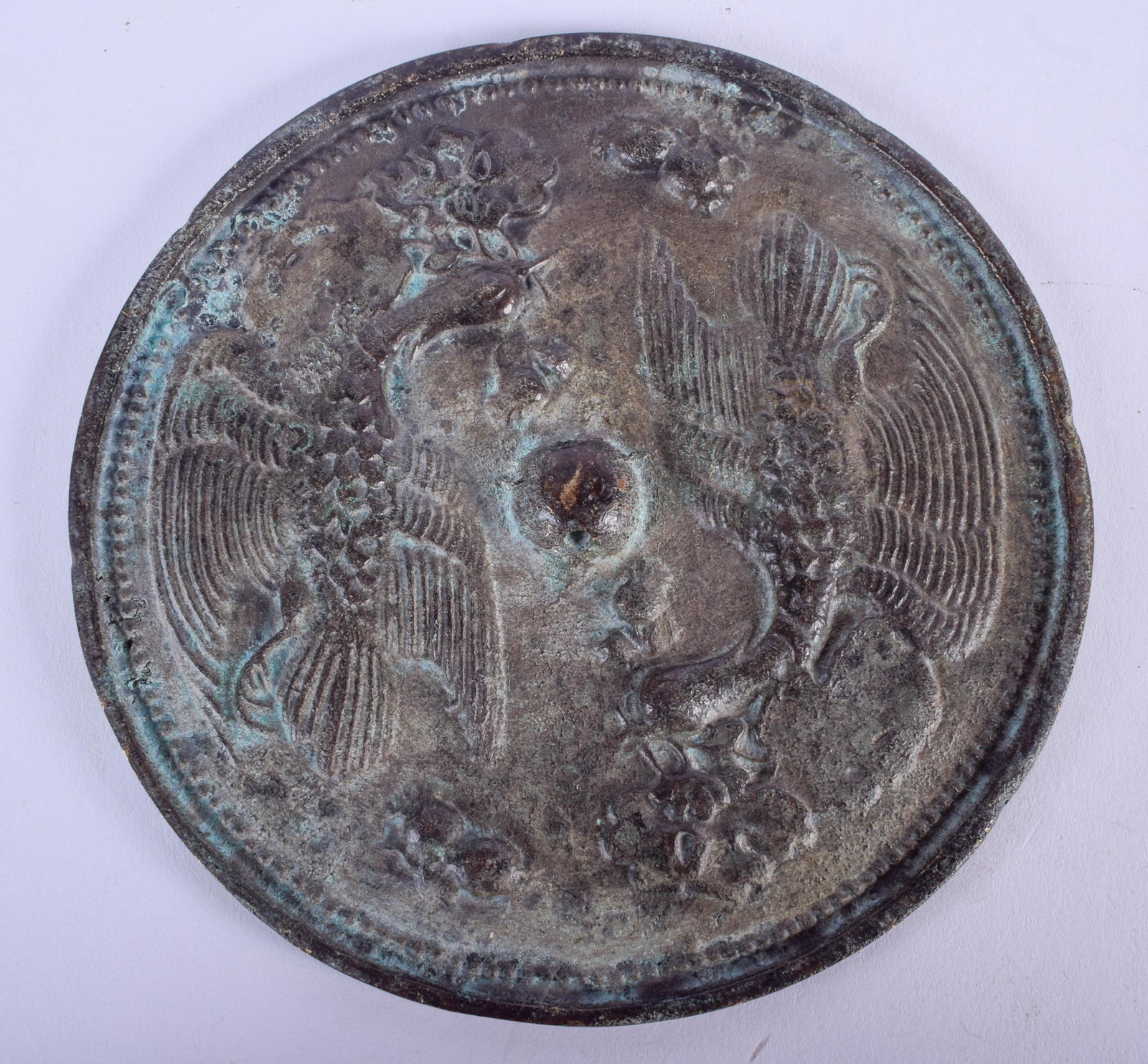 A CHINESE BRONZE HAND MIRROR. 11 cm wide.: A CHINESE BRONZE HAND MIRROR. 11 cm wide.