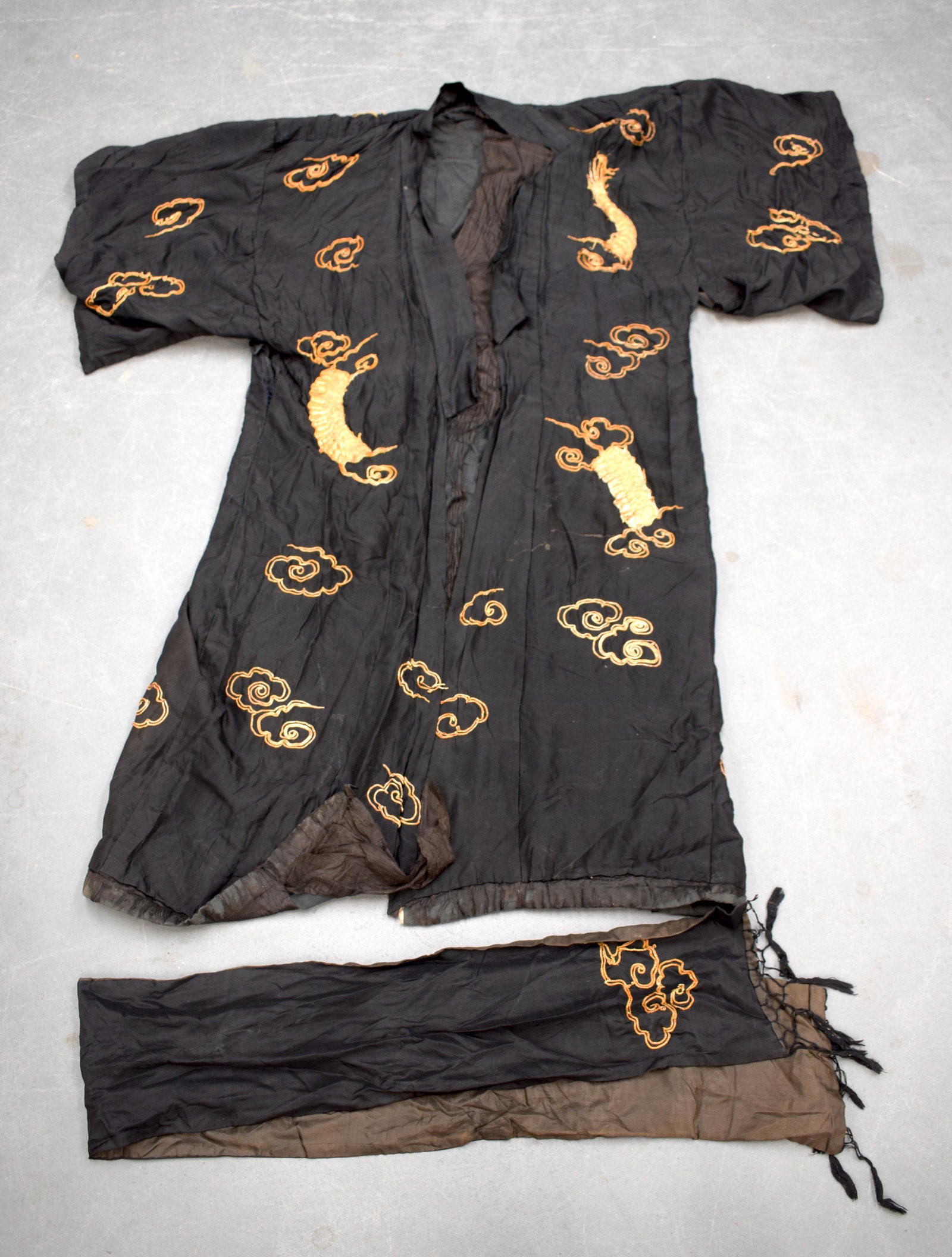 A JAPANESE SILK KIMONO together with two Middle Eastern: A JAPANESE SILK KIMONO together with two Middle Eastern silk panels. (3)