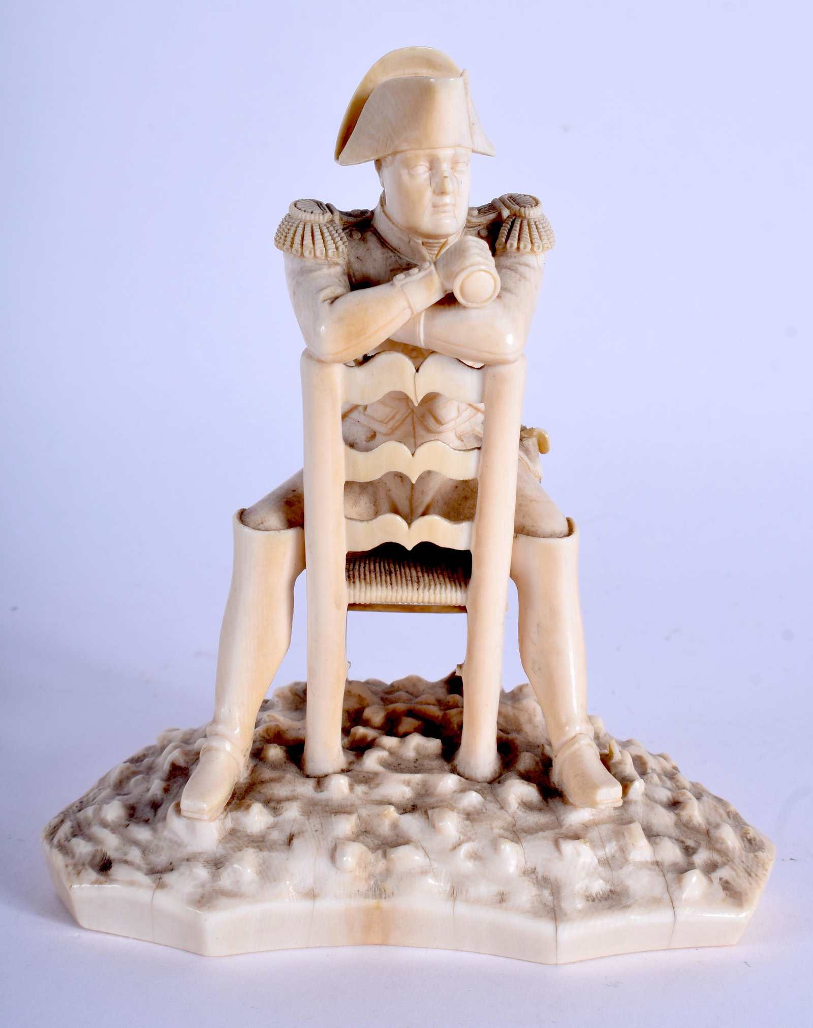A RARE 19TH CENTRY CENTURY EUROPEAN CARVED DIEPPE BONE: A RARE 19TH CENTRY CENTURY EUROPEAN CARVED DIEPPE BONE FIGURE OF NAPOLEON modelled upon a voyeur chair. 13 cm x 8 cm.