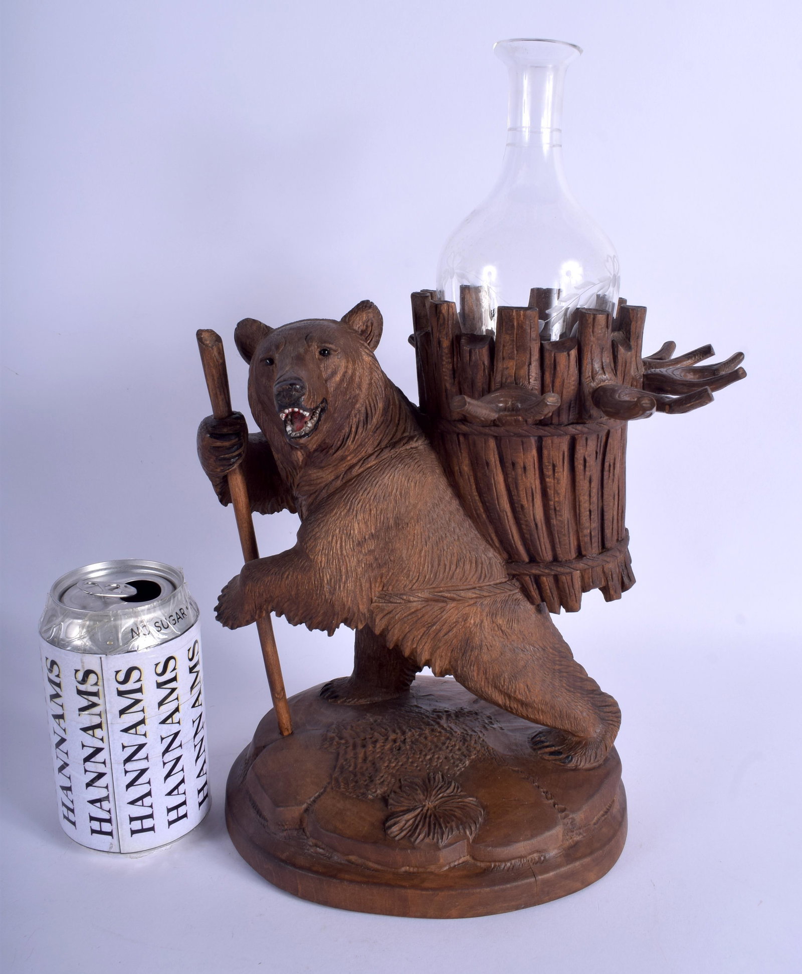 A 19TH CENTURY BAVARIAN BLACK FOREST DECANTER HOLDER in: A 19TH CENTURY BAVARIAN BLACK FOREST DECANTER HOLDER in the form of a standing bear. 27 cm x 16 cm.