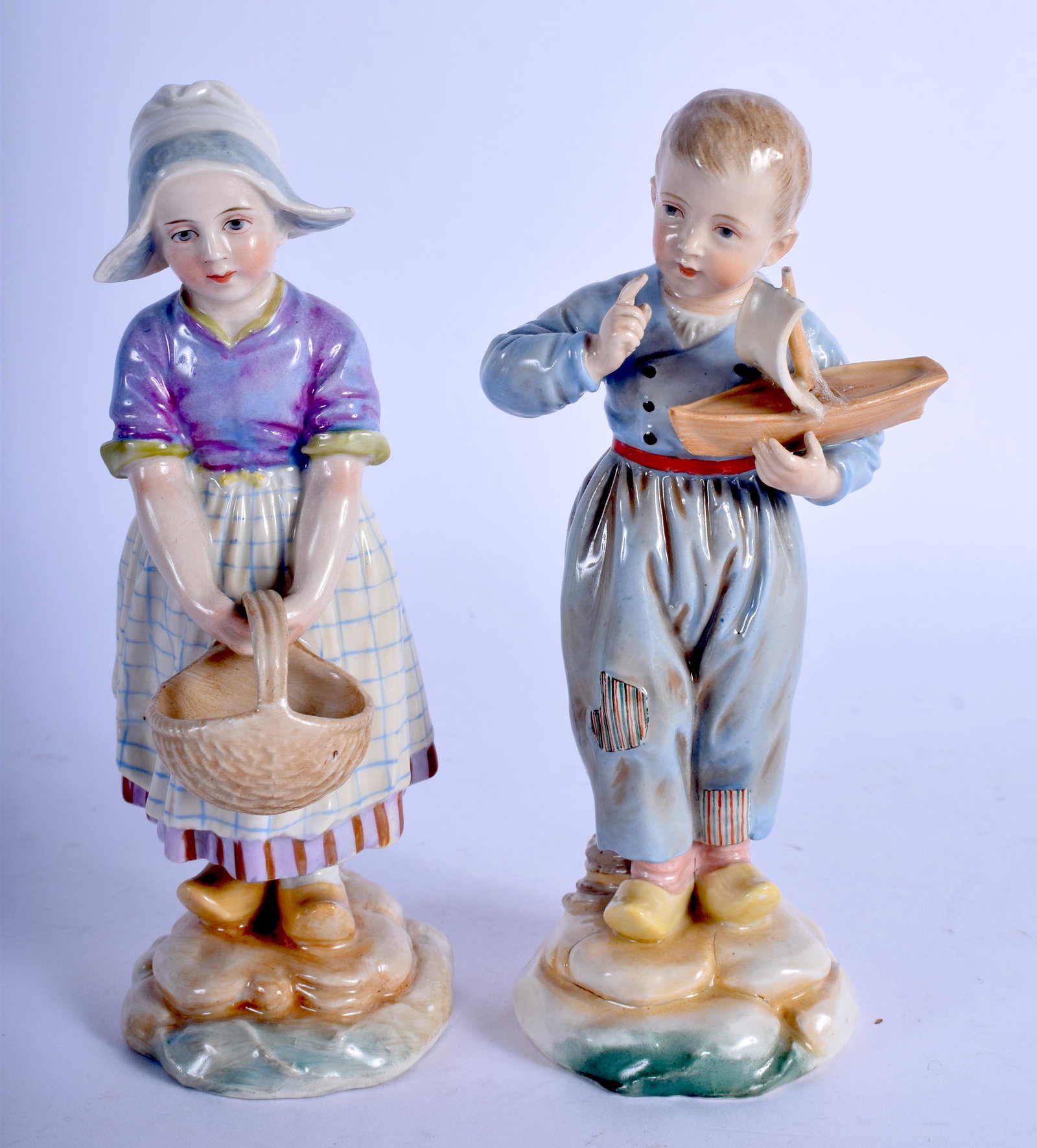 A PAIR OF 19TH CENTURY GERMAN PORCELAIN FIGURES: A PAIR OF 19TH CENTURY GERMAN PORCELAIN FIGURES possibly Hoscht, one holding a toy boat. 15 cm high.