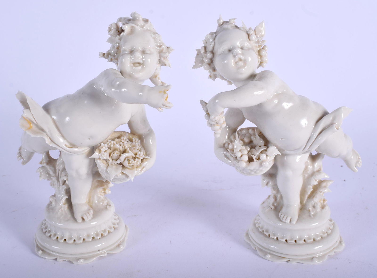 A PAIR OF EARLY 20TH CENTURY WHITE GLAZED PORCELAIN: A PAIR OF EARLY 20TH CENTURY WHITE GLAZED PORCELAIN FIGURES modelled upon a shaped base. 16 cm high.
