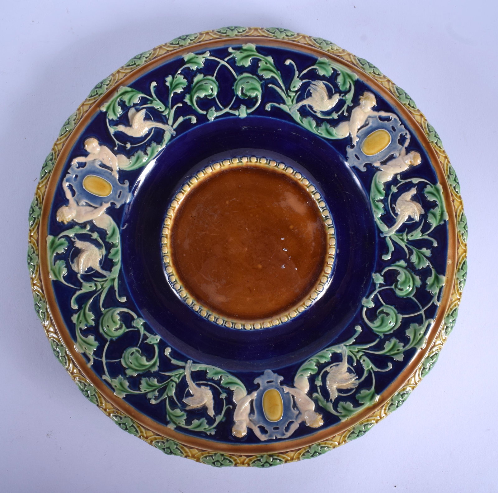 A 19TH CENTURY MINTON MAJOLICA CIRCULAR DISH decorated: A 19TH CENTURY MINTON MAJOLICA CIRCULAR DISH decorated with figures and foliage. 24 cm diameter.
