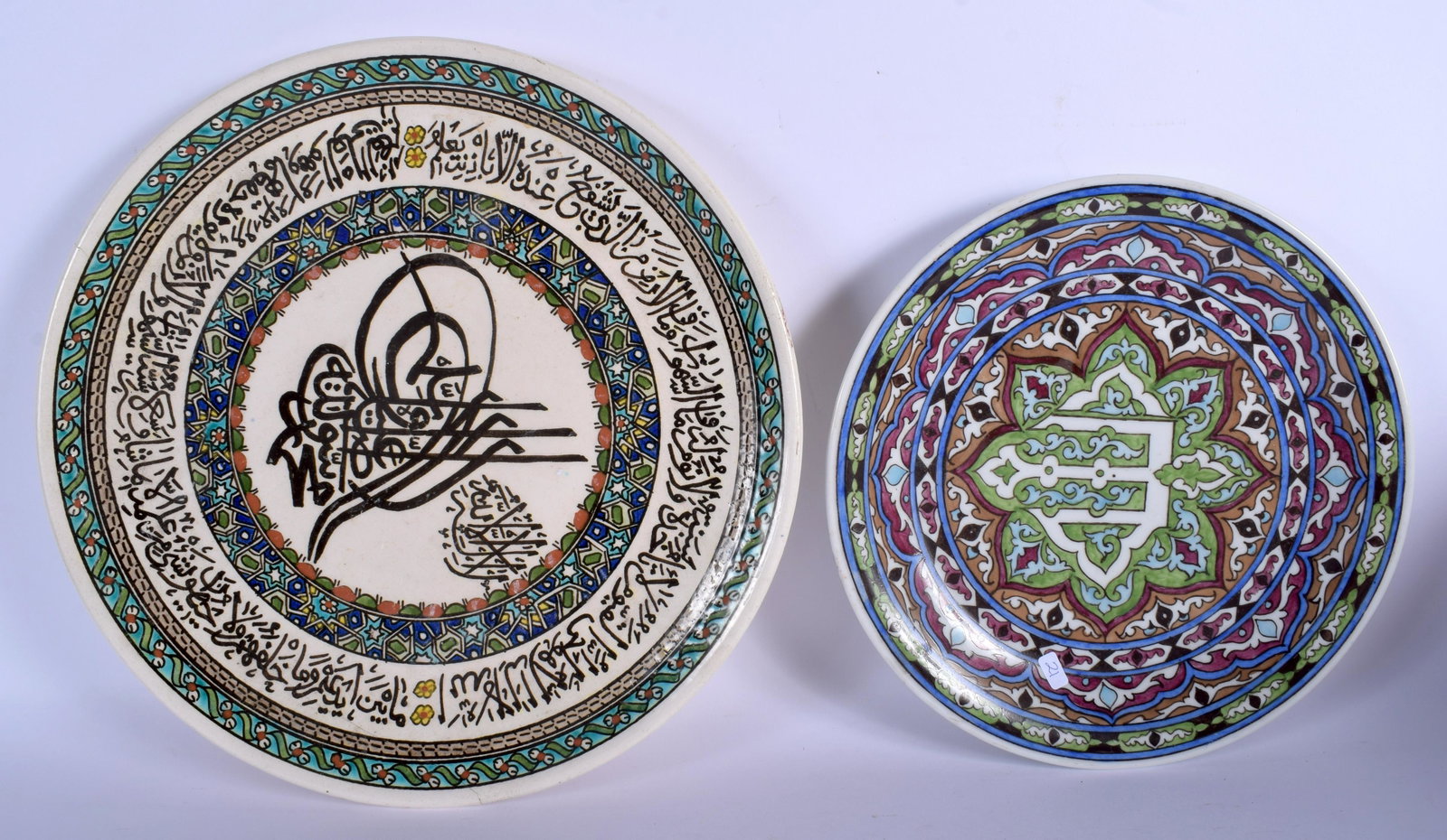 TWO ISLAMIC MIDDLE EASTERN POTTERY FAIENCE DISHES.: TWO ISLAMIC MIDDLE EASTERN POTTERY FAIENCE DISHES. Largest 31.5 cm diameter. (2)