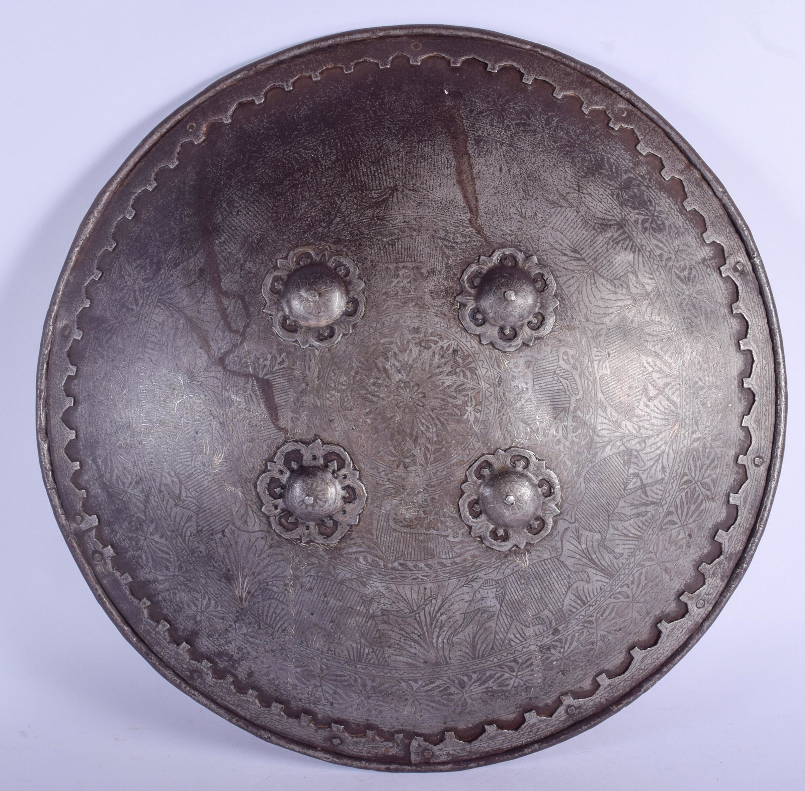 AN 18TH CENTURY MIDDLE EASTERN INDIAN IRON SHIELD: AN 18TH CENTURY MIDDLE EASTERN INDIAN IRON SHIELD decorated with silver inlay, depicting animals. 38 cm diameter.