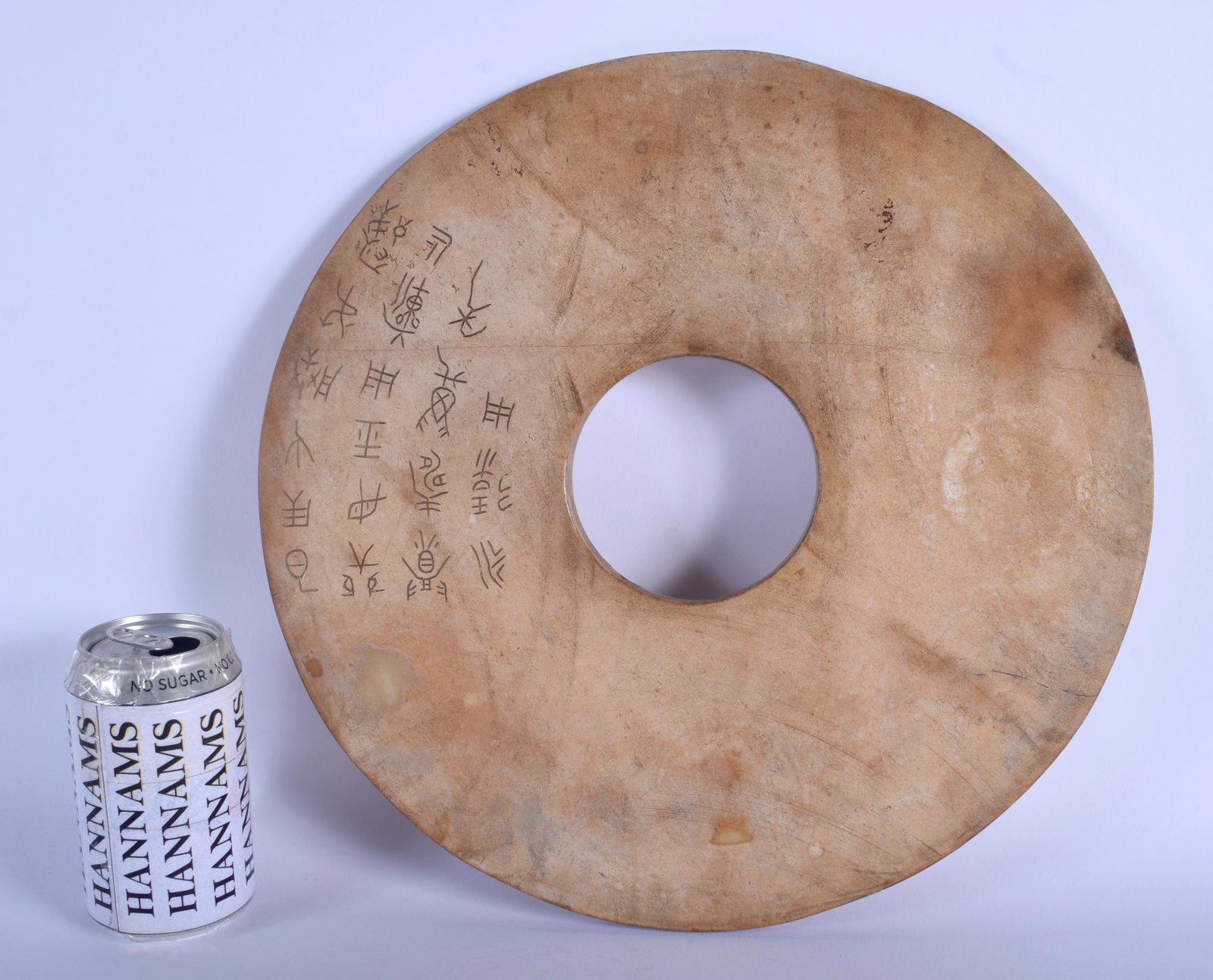 A LARGE CHINESE QING DYNASTY CIRCULAR JADE BI DISC: A LARGE CHINESE QING DYNASTY CIRCULAR JADE BI DISC Shang Dynasty style, Bo Hou, decorated with calligraphy. 34 cm wide.