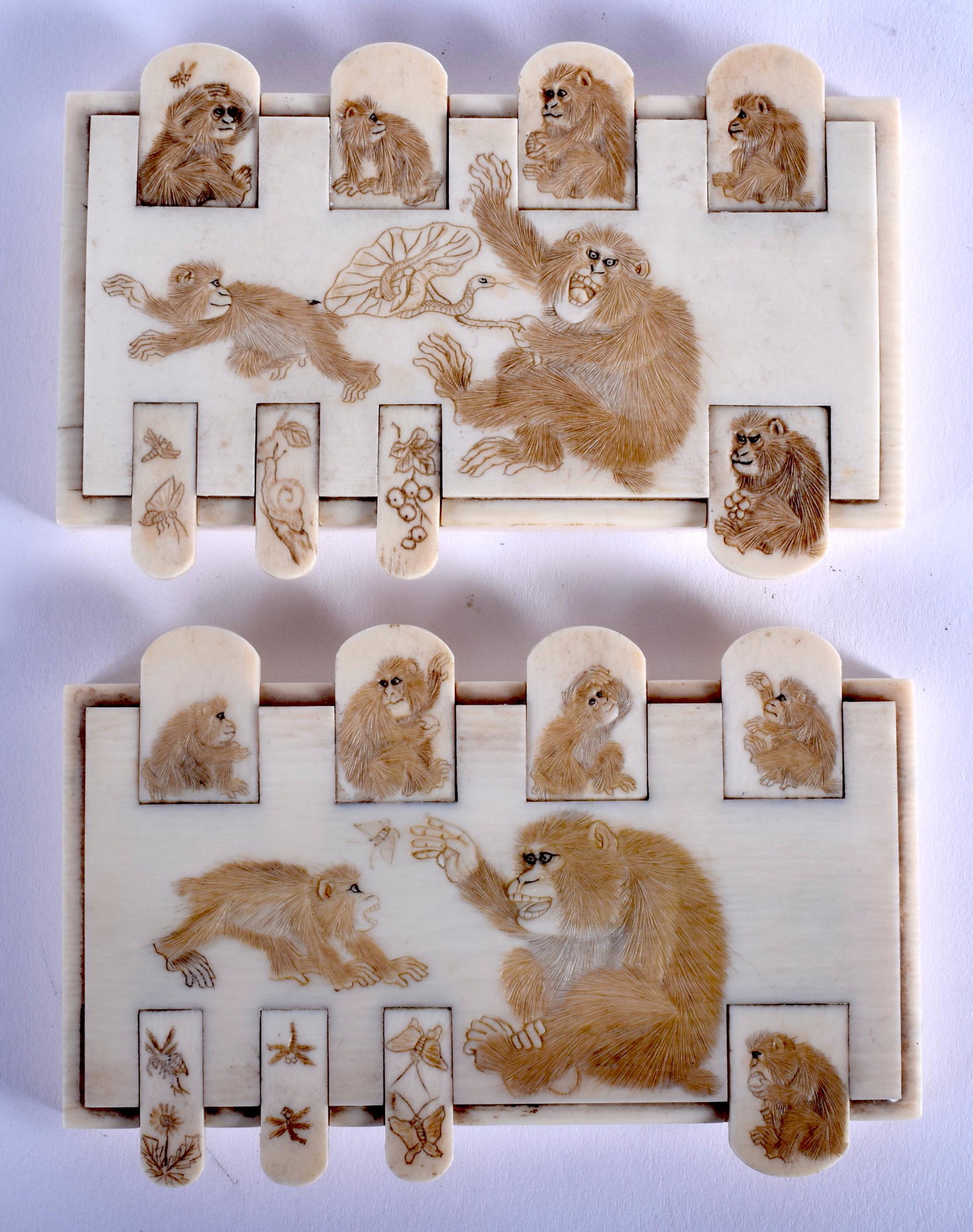 A PAIR OF 19TH CENTURY JAPANESE MEIJI PERIOD CARVED: A PAIR OF 19TH CENTURY JAPANESE MEIJI PERIOD CARVED bone WHIST MARKERS decorated with seated chimps. 9 cm x 5.5 cm.