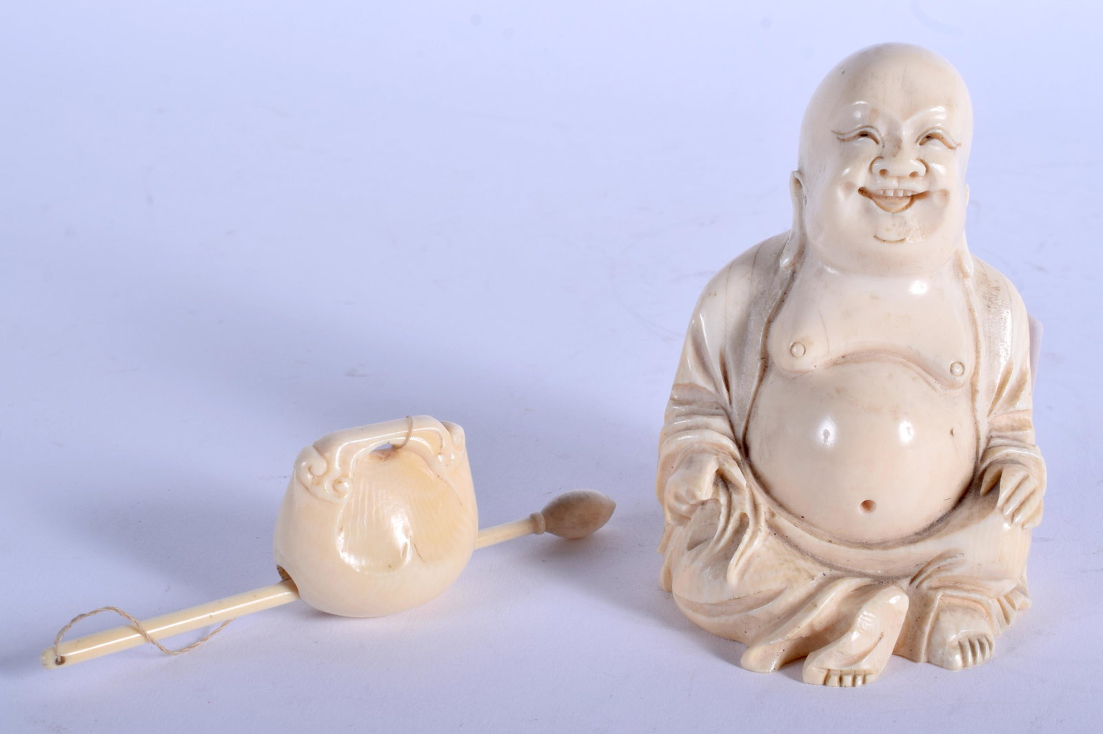 A 19TH CENTURY CHINESE CARVED bone FIGURE OF A BUDDHA: A 19TH CENTURY CHINESE CARVED bone FIGURE OF A BUDDHA Late Qing, together with an bone pole. Buddha 10 cm x 6 cm. (2)