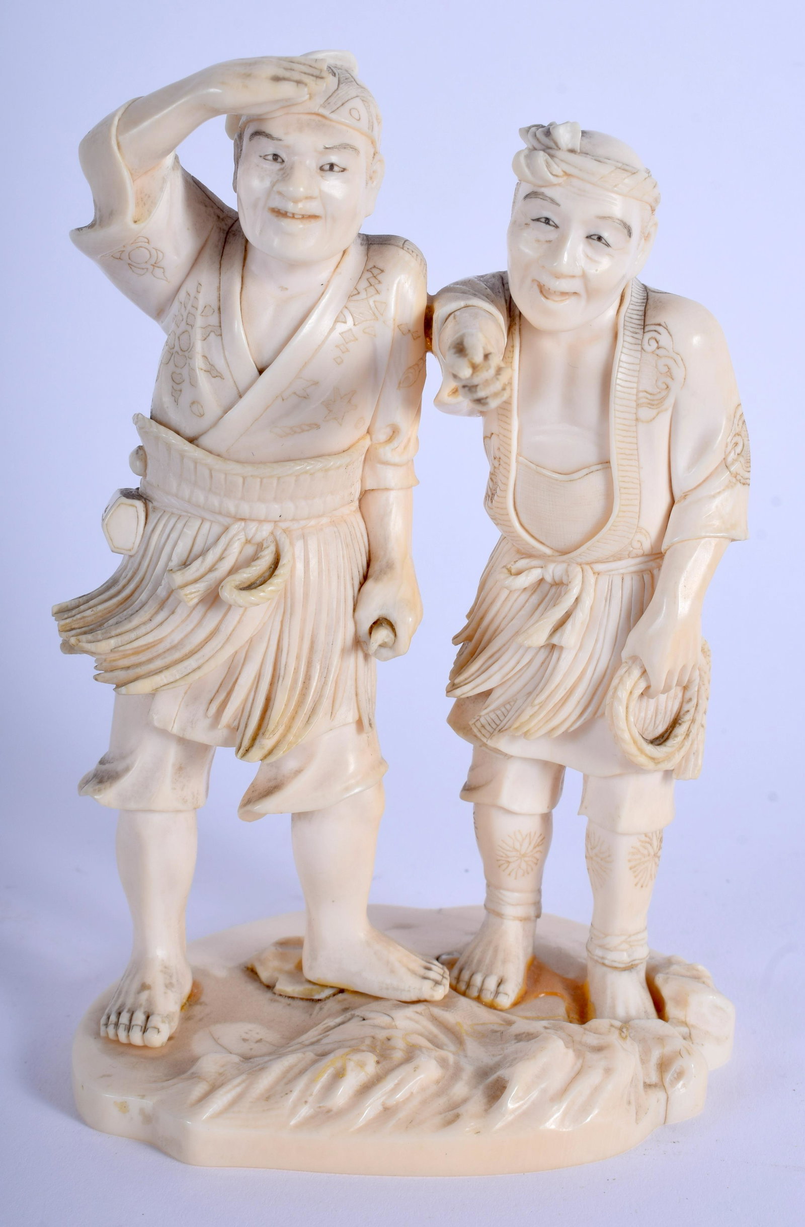 A 19TH CENTURY JAPANESE MEIJI PERIOD CARVED bone: A 19TH CENTURY JAPANESE MEIJI PERIOD CARVED bone OKIMONO modelled as two scholars upon a shaped base. 14 cm x 6 cm.