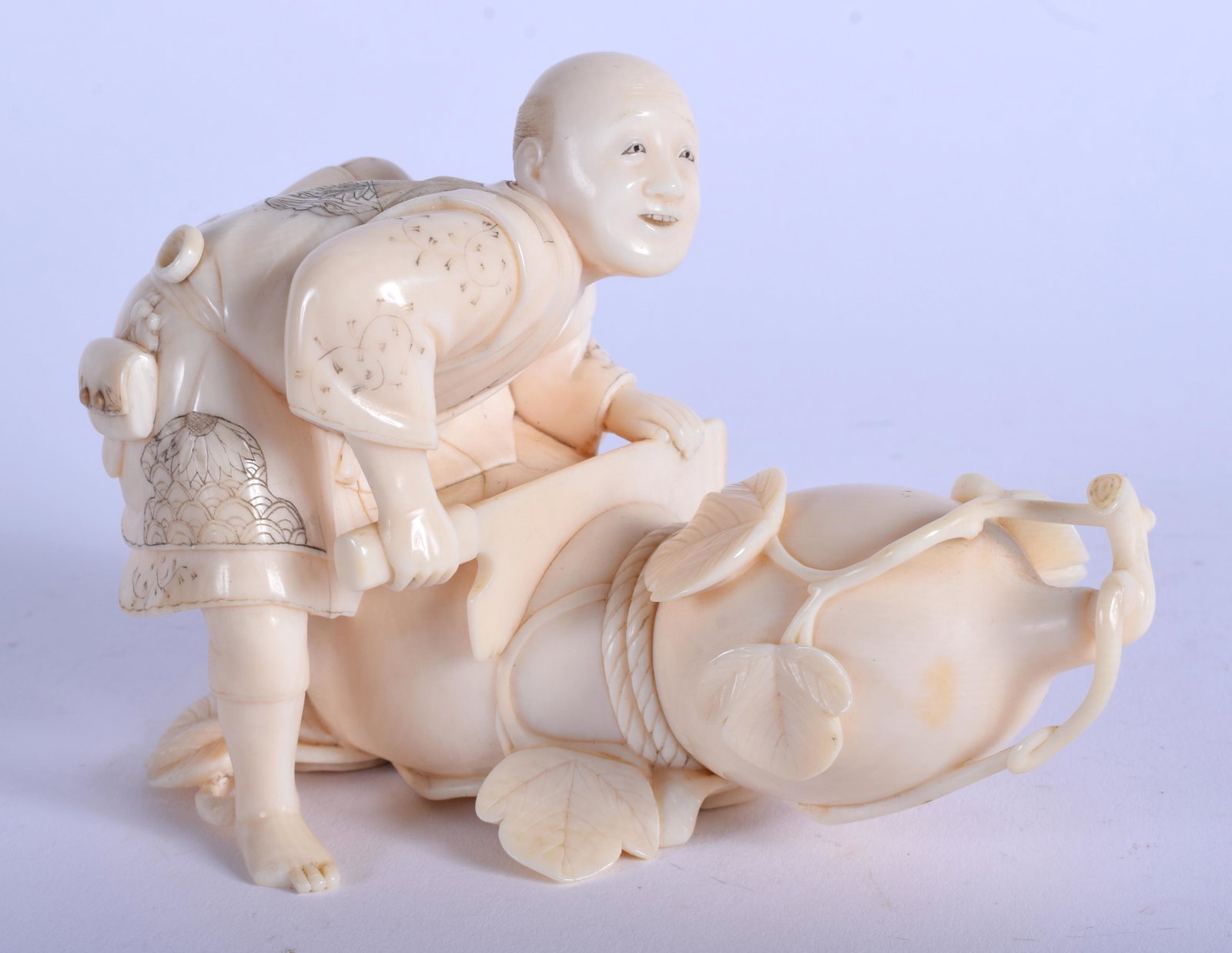 A 19TH CENTURY JAPANESE MEIJI PERIOD CARVED BONE: A 19TH CENTURY JAPANESE MEIJI PERIOD CARVED BONE OKIMONO modelled seated upon a vegetable. 10 cm x 7.5 cm.