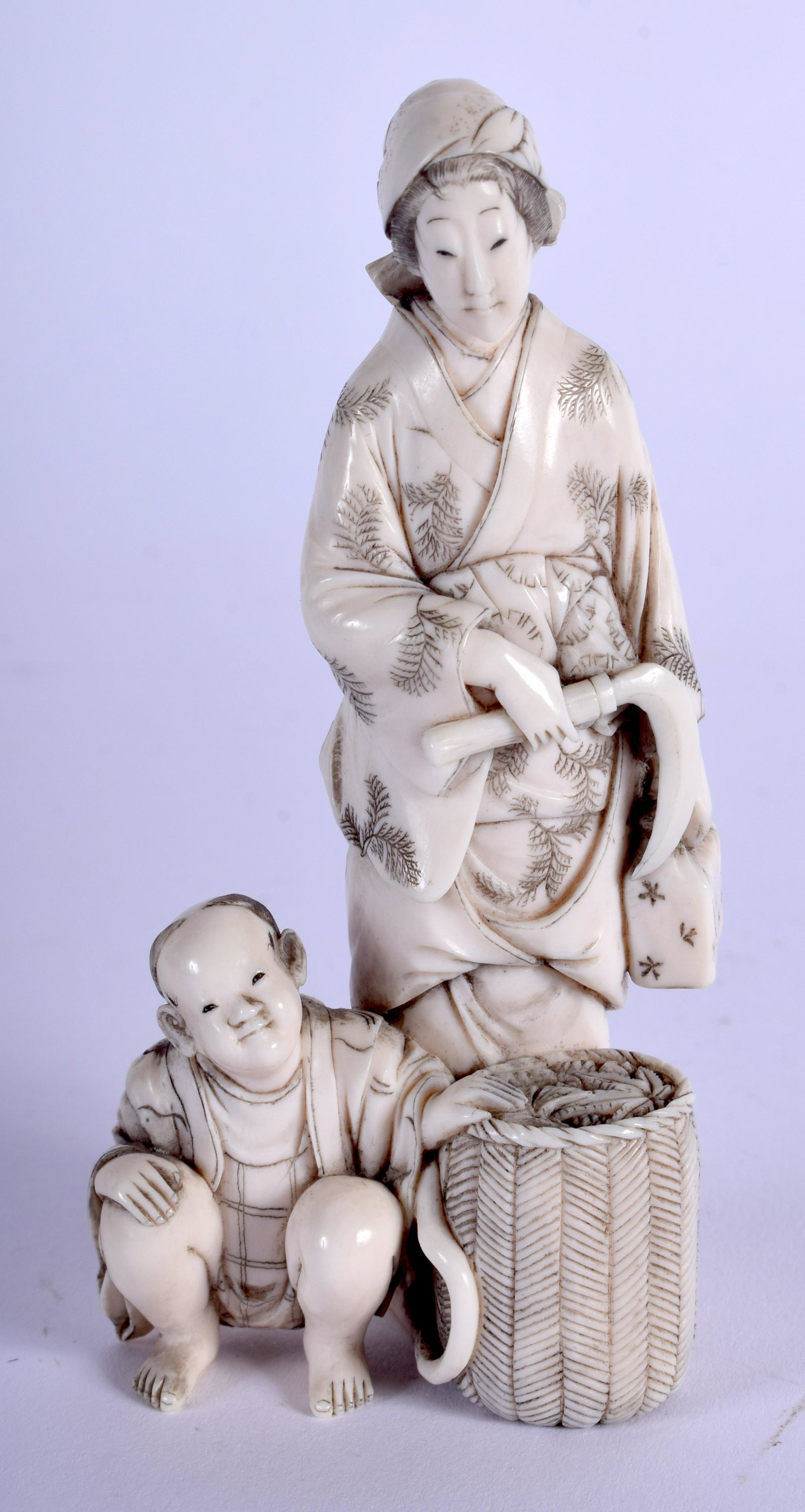 A 19TH CENTURY JAPANESE MEIJI PERIOD CARVED BONE: A 19TH CENTURY JAPANESE MEIJI PERIOD CARVED BONE OKIMONO modelled as a female beside a boy. 9.5 cm x 4 cm.
