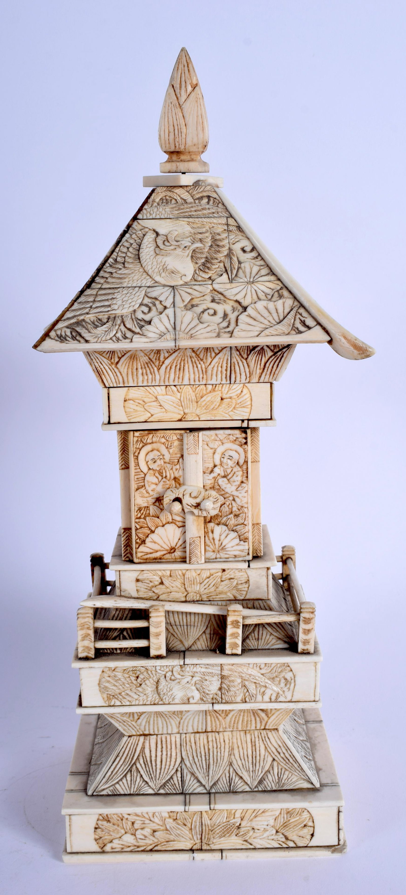 A 19TH CENTURY JAPANESE MEIJI PERIOD CARVED BONE PAGODA: A 19TH CENTURY JAPANESE MEIJI PERIOD CARVED BONE PAGODA inset with a seated buddha. 30 cm x 8 cm.