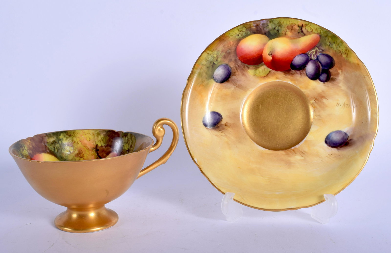 Royal Worcester fruit painted teacup and saucer with: Royal Worcester fruit painted teacup and saucer with shaped rims both signed by H. Ayrton, date codes for 1930/31. Saucer 14.5cm diameter