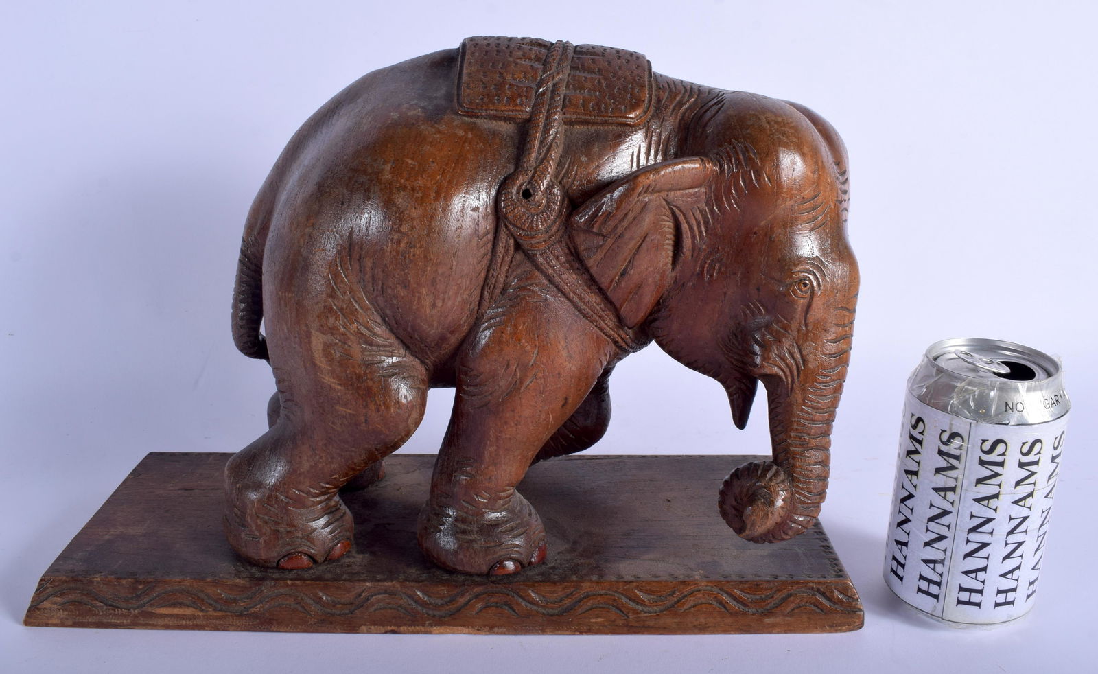 A LARGE ANTIQUE ANGLO INDIAN CARVED HARDWOOD FIGURE OF: A LARGE ANTIQUE ANGLO INDIAN CARVED HARDWOOD FIGURE OF AN ELEPHANT modelled upon a rectangular base. 33 cm x 26 cm.
