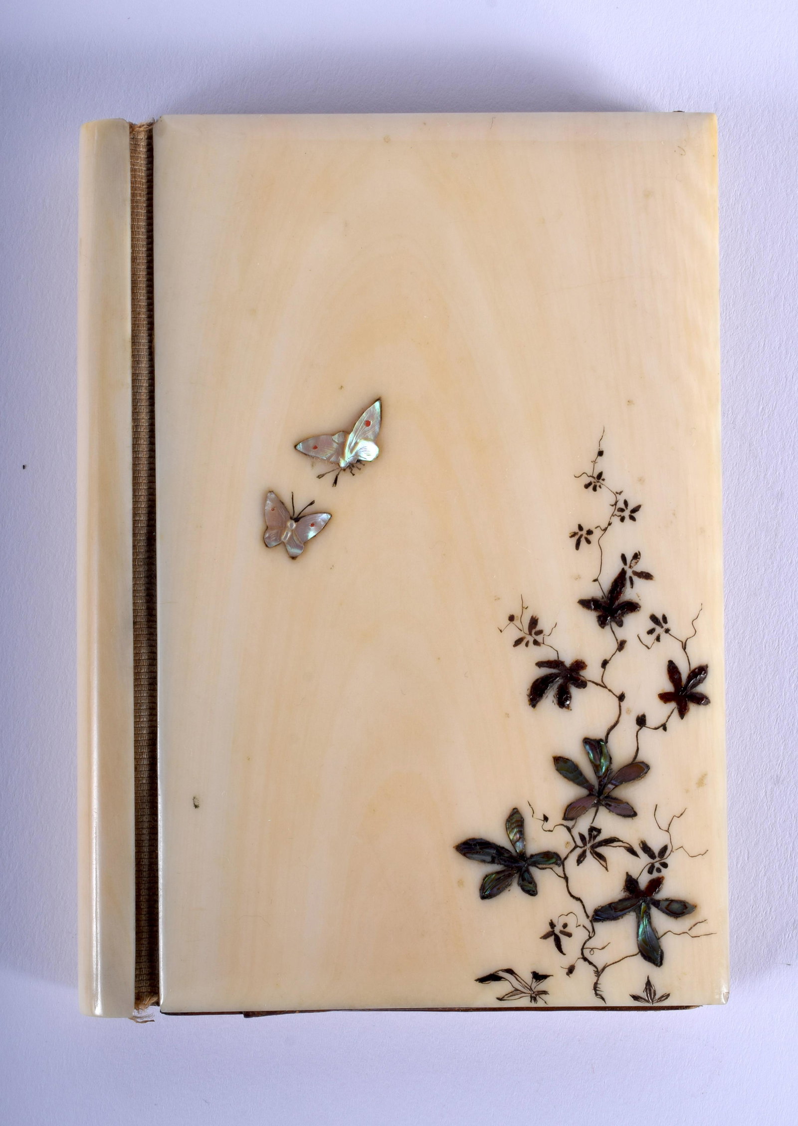 A 19TH CENTURY JAPANESE MEIJI PERIOD CARVED BONE: A 19TH CENTURY JAPANESE MEIJI PERIOD CARVED BONE SHIBAYAMA INLAID AIDE MEMOIRE decorated with birds and insects. 7 cm x 10 cm.