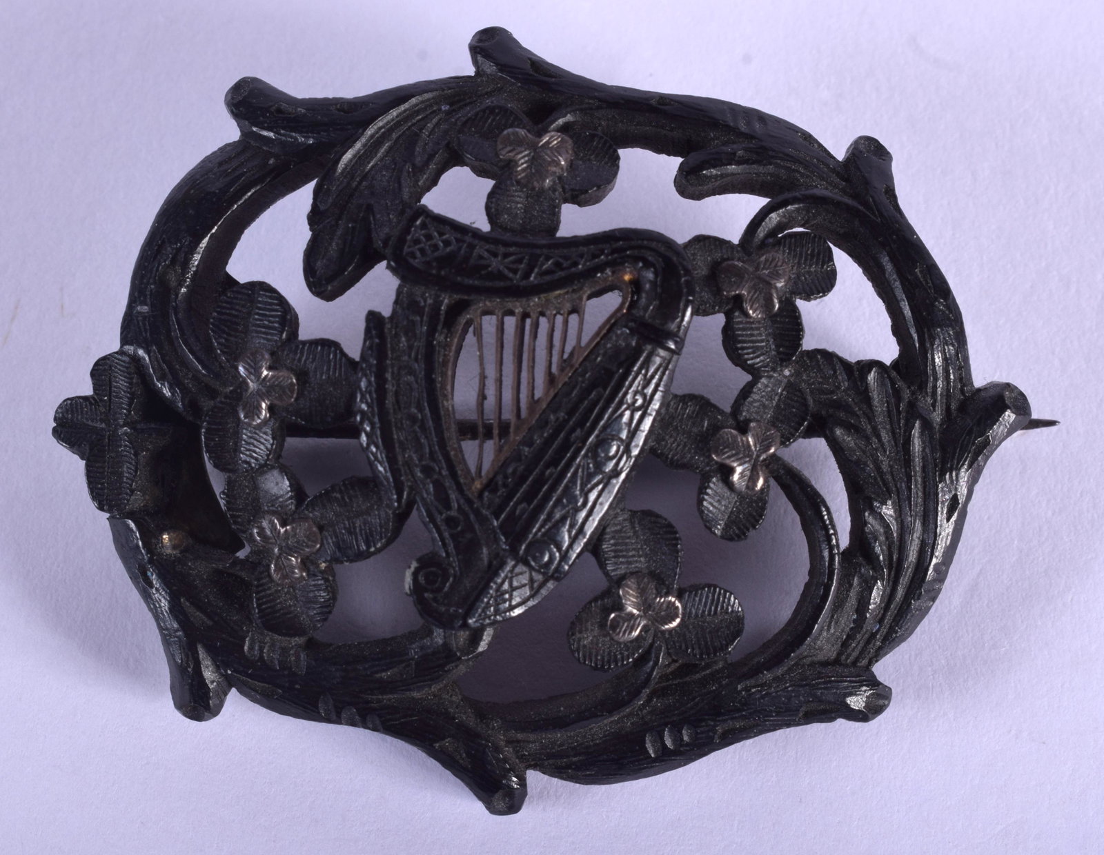 A 19TH CENTURY IRISH CARVED BOG OAK HARP BROOCH. 5.5 cm: A 19TH CENTURY IRISH CARVED BOG OAK HARP BROOCH. 5.5 cm x 3.5 cm.