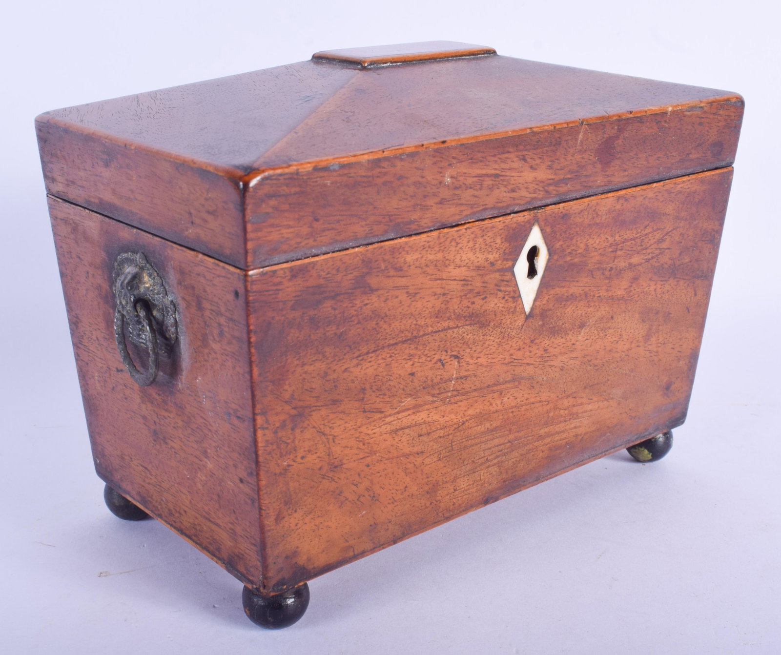 A GEORGE III MAHOGANY TEA CADDY containing numerous: A GEORGE III MAHOGANY TEA CADDY containing numerous gaming counters. 18 cm x 14 cm.