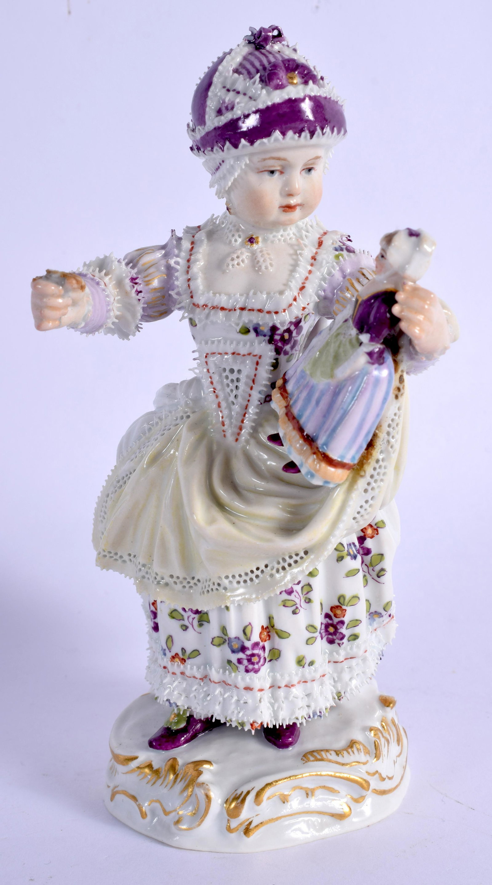 Meissen crinoline figure of a girl holding a doll,: Meissen crinoline figure of a girl holding a doll, crossed swords in blue. 14.5cm high