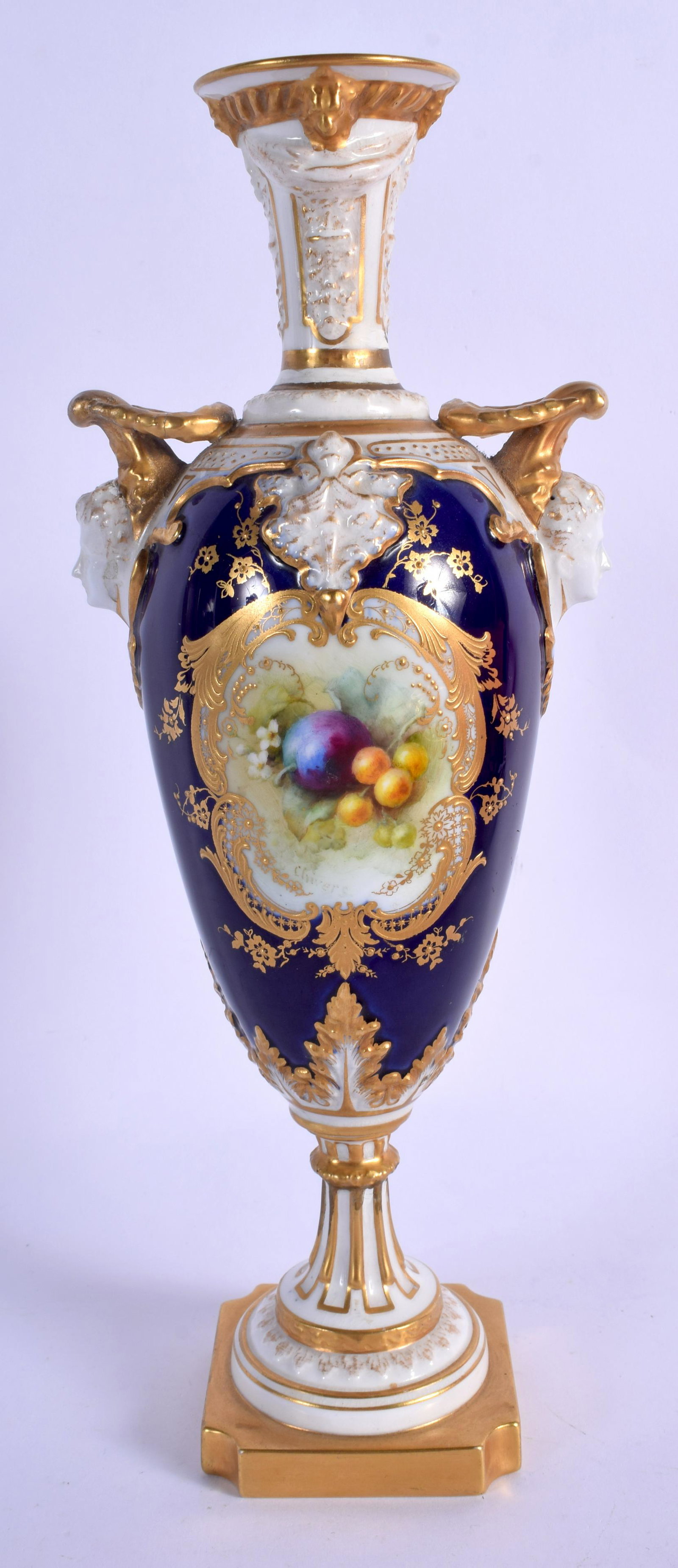 Royal Worcester vase with two headed handles painted: Royal Worcester vase with two headed handles painted with fruit in a highly gilded panel on a cobalt blue ground date by F. Chivers code for 1906. 27.5cm high