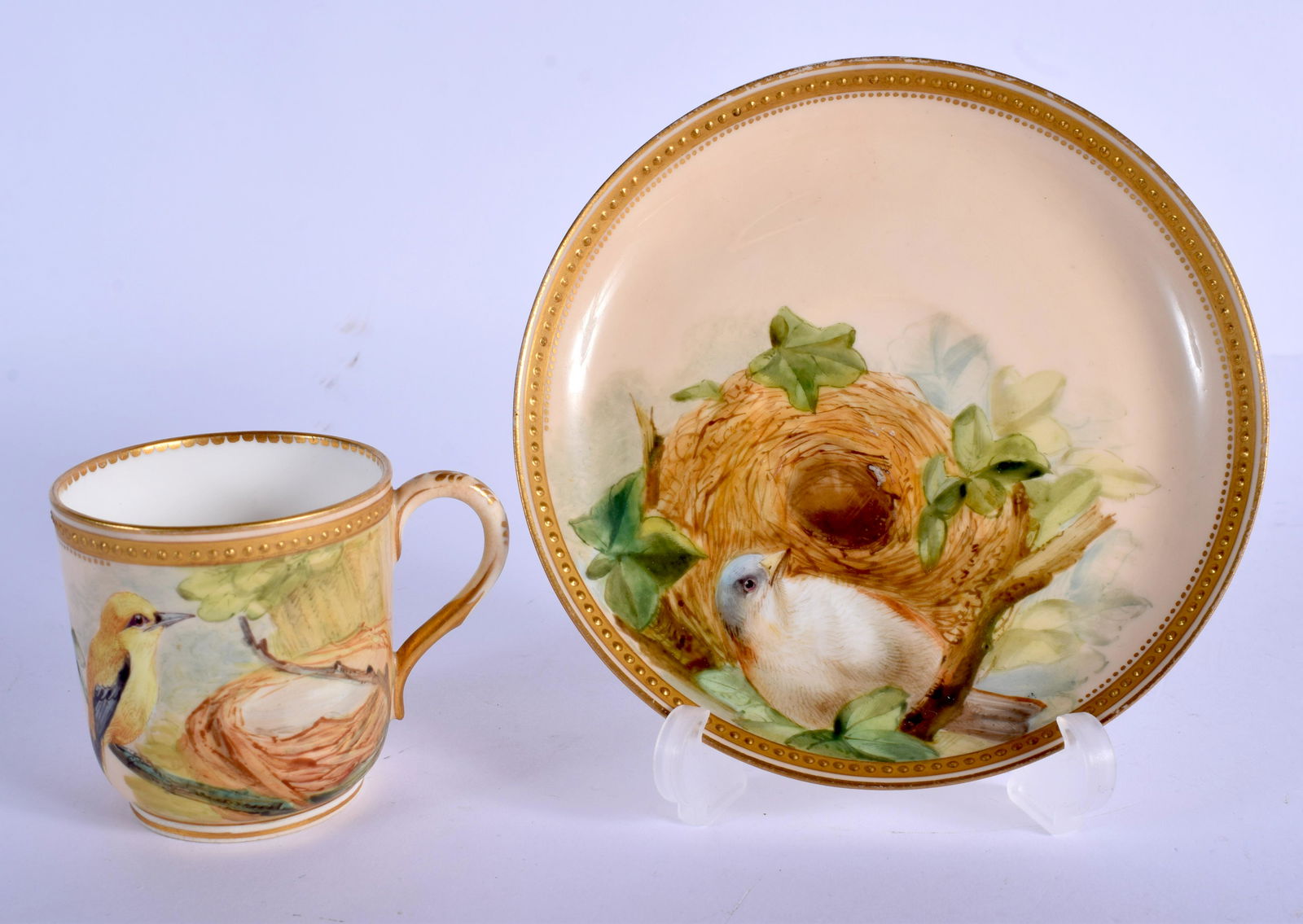 Royal Worcester fine coffee cup and saucer painted with: Royal Worcester fine coffee cup and saucer painted with birds and their nests by David Bates, dated 1874 NB. Bates left Royal Worcester and became a very successful oil and watercolour painter. Cup 6c