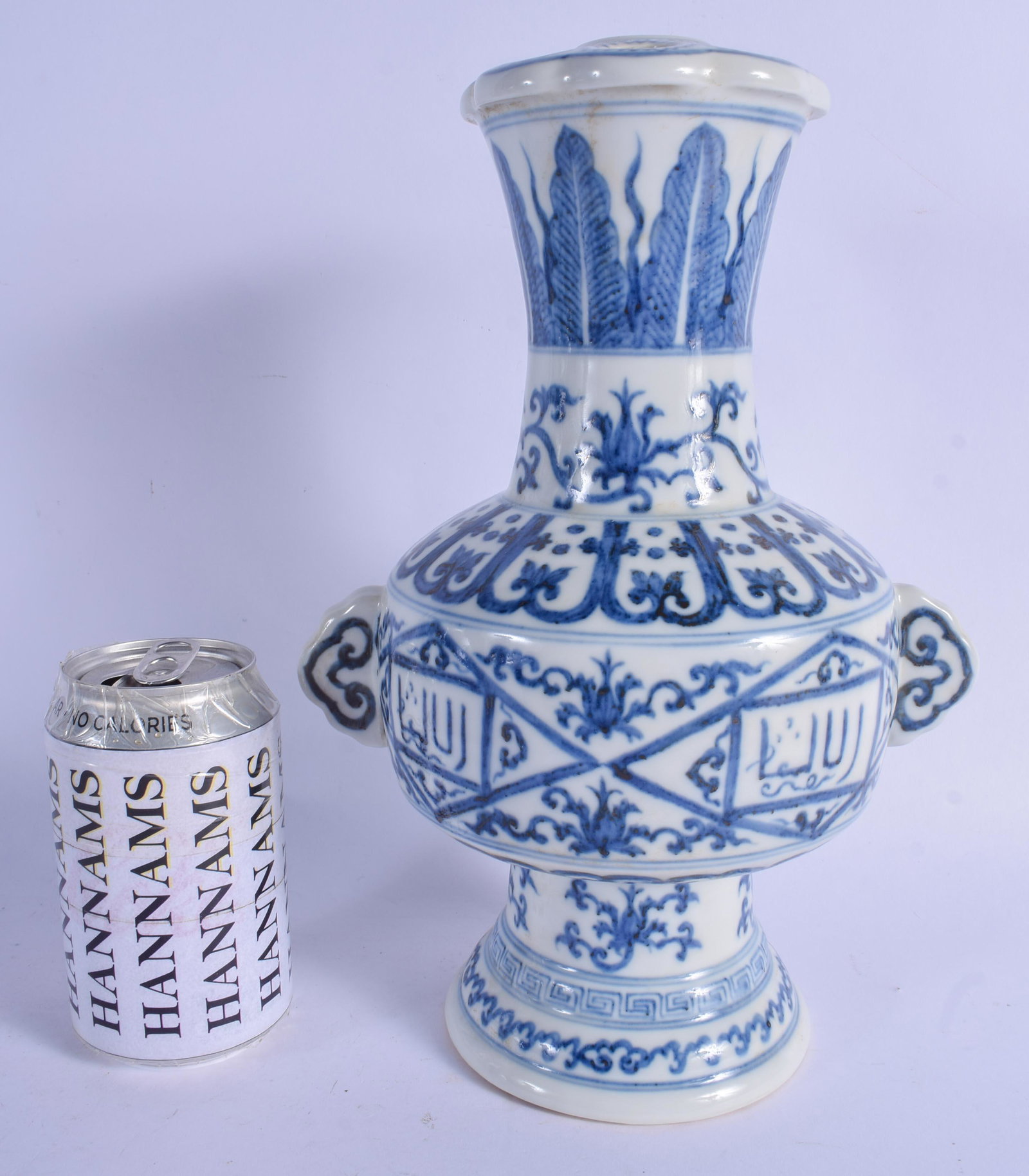 A CHINESE TWIN HANDLED ISLAMIC MARKET VASE 20th: A CHINESE TWIN HANDLED ISLAMIC MARKET VASE 20th Century, painted with flowers and calligraphy. 30 cm x 15 cm.