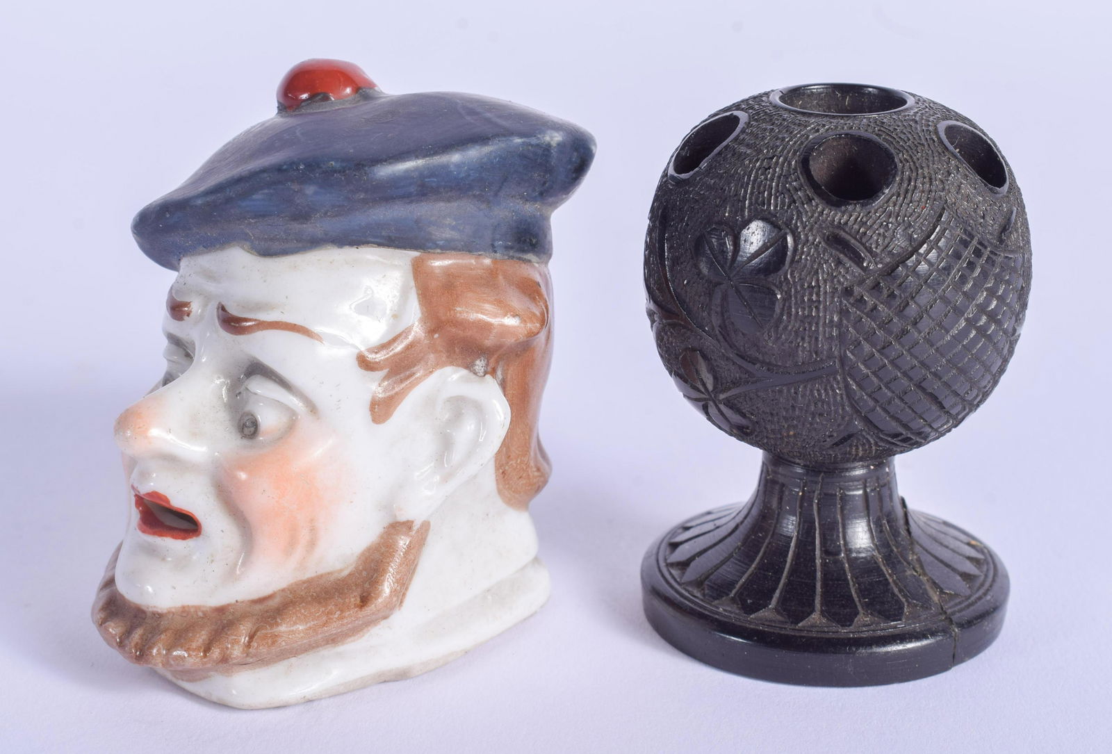 AN IRISH BOG OAK PIN HOLDER and a porcelain head. (2) (1 of 3)