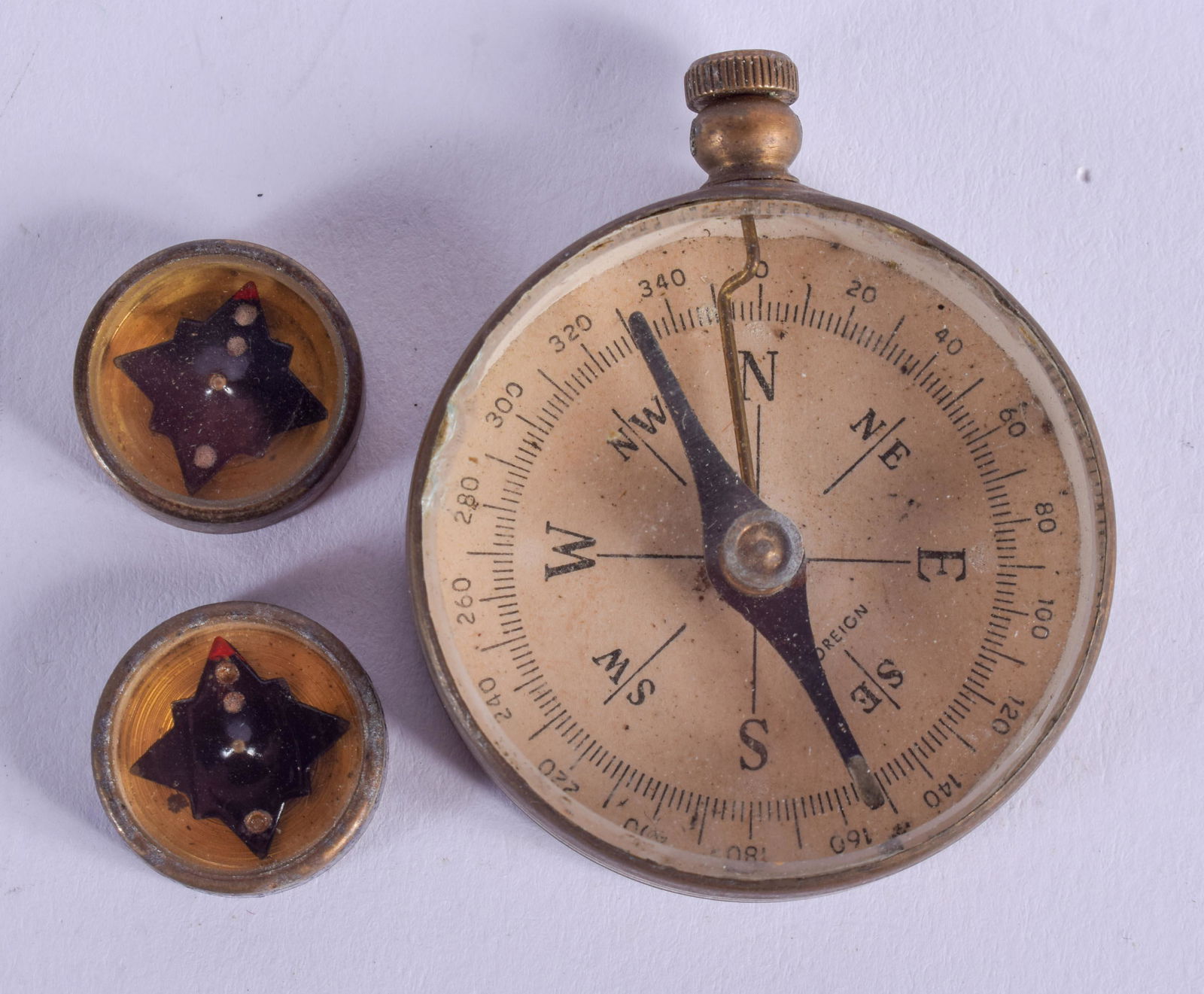 A VINTAGE COMPASS and similar miniature compass. (3) (1 of 2)