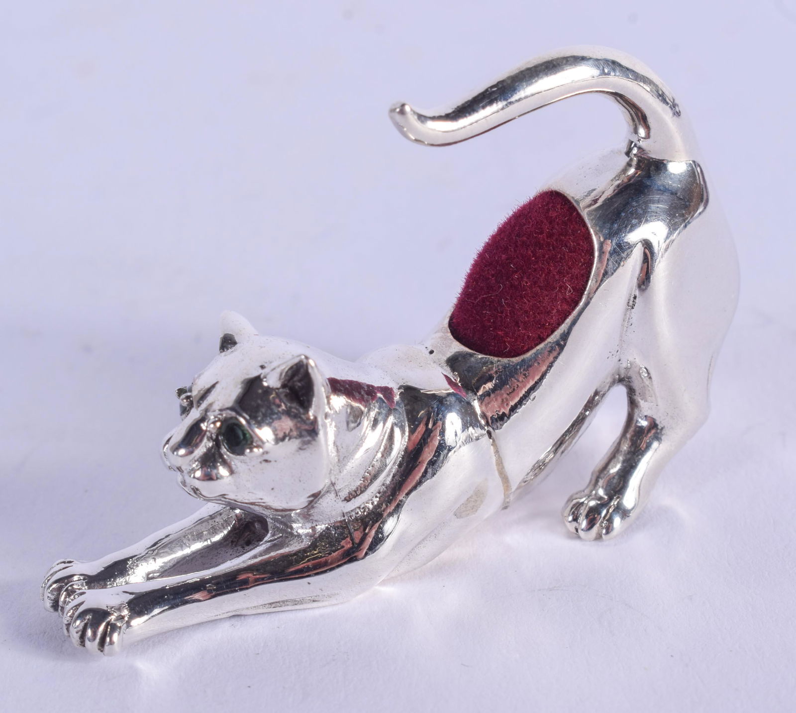 A SILVER CAT PIN CUSHION. 3 cm x 2.5 cm. (1 of 3)