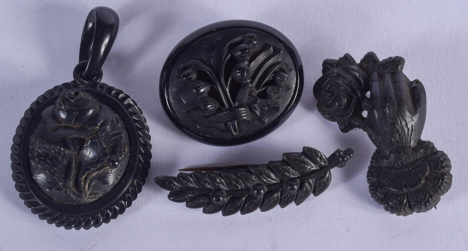 FOUR ANTIQUE JET BROOCHES. Largest 4 cm x 4.5 cm. (4) (1 of 2)