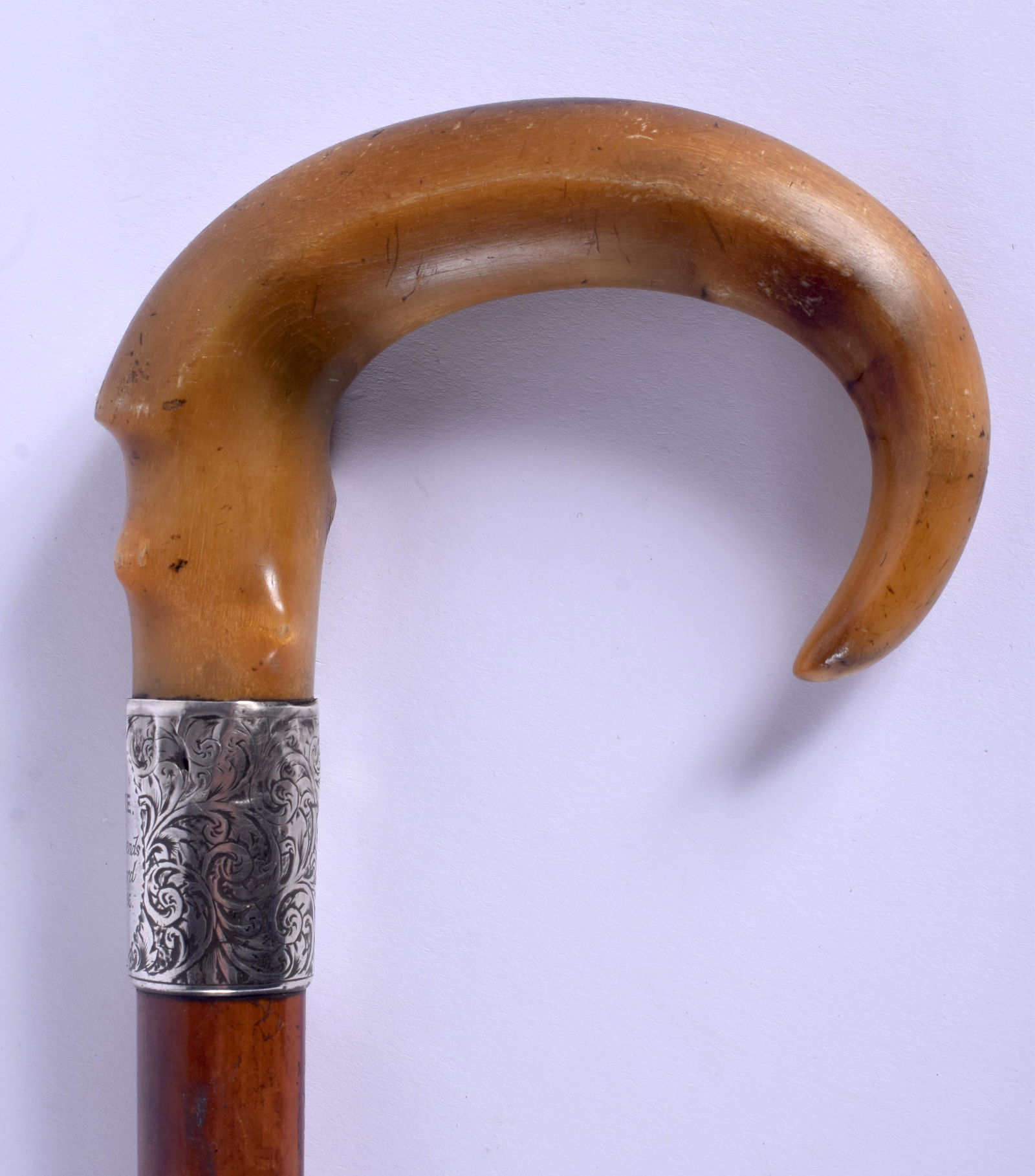 A 19TH CENTURY CONTINENTAL CARVED BUFFALO HORN WALKING: A 19TH CENTURY CONTINENTAL CARVED BUFFALO HORN WALKING CANE with silver mounts. 88 cm long.