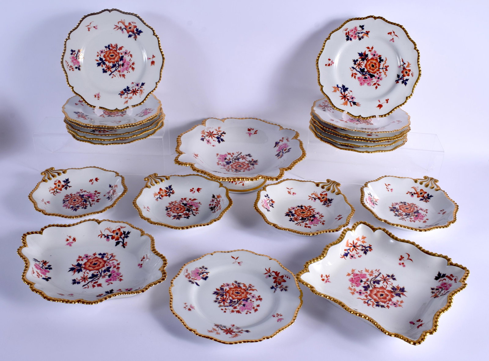 19TH C. WORCESTER FLIGHT BARR AND BARR DESSERT SERVICE: 19TH C. WORCESTER FLIGHT BARR AND BARR DESSERT SERVICE painted with oriental style flowers under a gadroon gilt border comprising: a pedestal fruit bowl, four shell dishes, an oval dish, a square dish