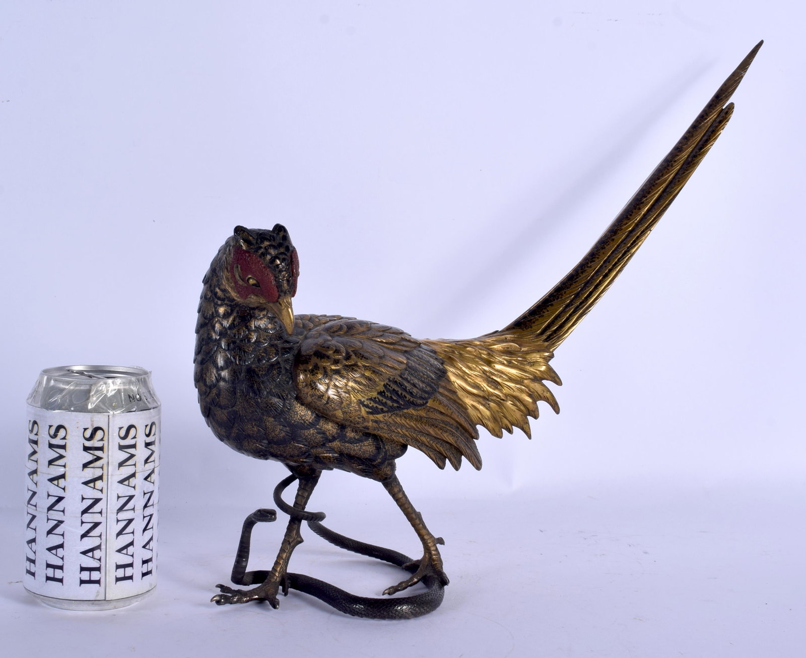 A GOOD LARGE 19TH CENTURY JAPANESE MEIJI PERIOD BRONZE: A GOOD LARGE 19TH CENTURY JAPANESE MEIJI PERIOD BRONZE OKIMONO modelled as a roaming bird stepped upon a serpent. 31 cm x 31 cm.